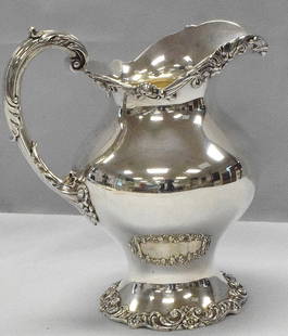 GORHAM STERLING SILVER PITCHER: Footed sterling silver pitcher by Gorham. 9 3/8 inches tall x 5 1/2 x 8 1/2 inches. Approx. 26.39 troy ounces. One small side dent.