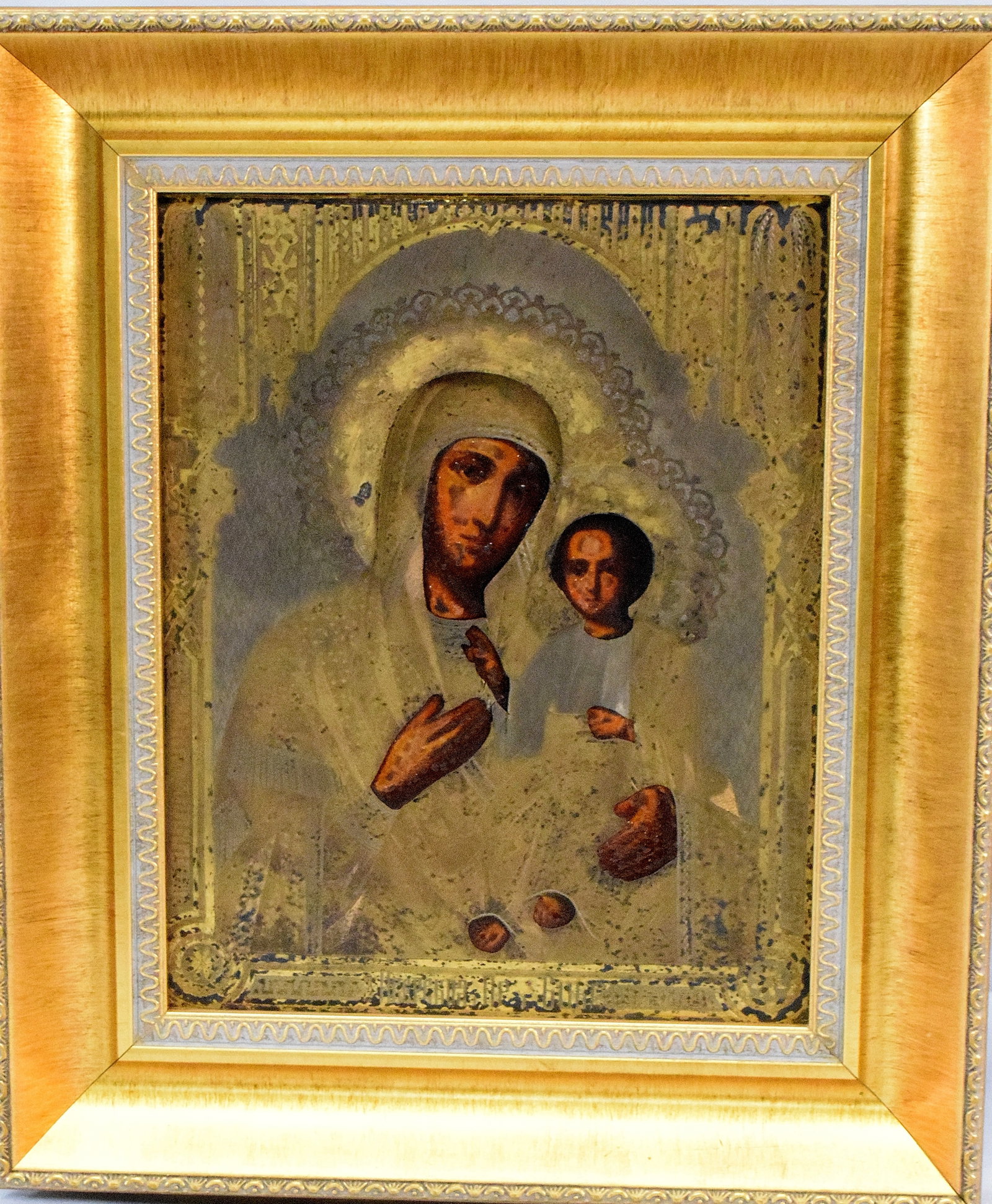 19TH/20TH C RUSSIAN ICON MARY & CHRIST CHILD: 19th/20th century Russian Orthodox icon with Virgin Mary and Christ Child, Wood panel backed with muslin liner. Engraved gilt metal over painted surface and raised gilt meal halos. Painted surfaces ar