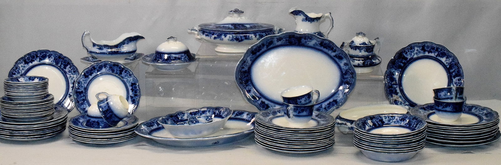 FLOW BLUE JOHNSON BROS. CHINA MONTANA PATTERN: 19th/20th Johnson Bros. Flow Blue china in the Montana pattern, made in England. Collection consists of approx. 95 pieces including platters, dinner, salad and dessert plates, gravy boat, covered butt