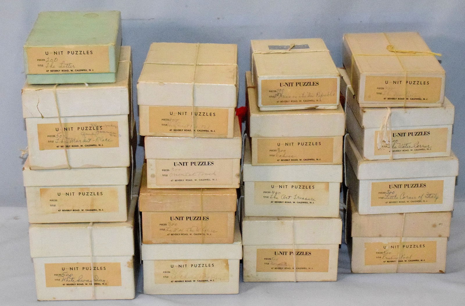 U-NIT ANTIQUE HAND CUT JIGSAW PUZZLE COLLECTION: 16 original vintage U-NIT puzzles. All are in original boxes with original labels. Hand cut wooden jigsaw puzzles. Color and condition look very good. We believe all pieces are present in each puzzle.