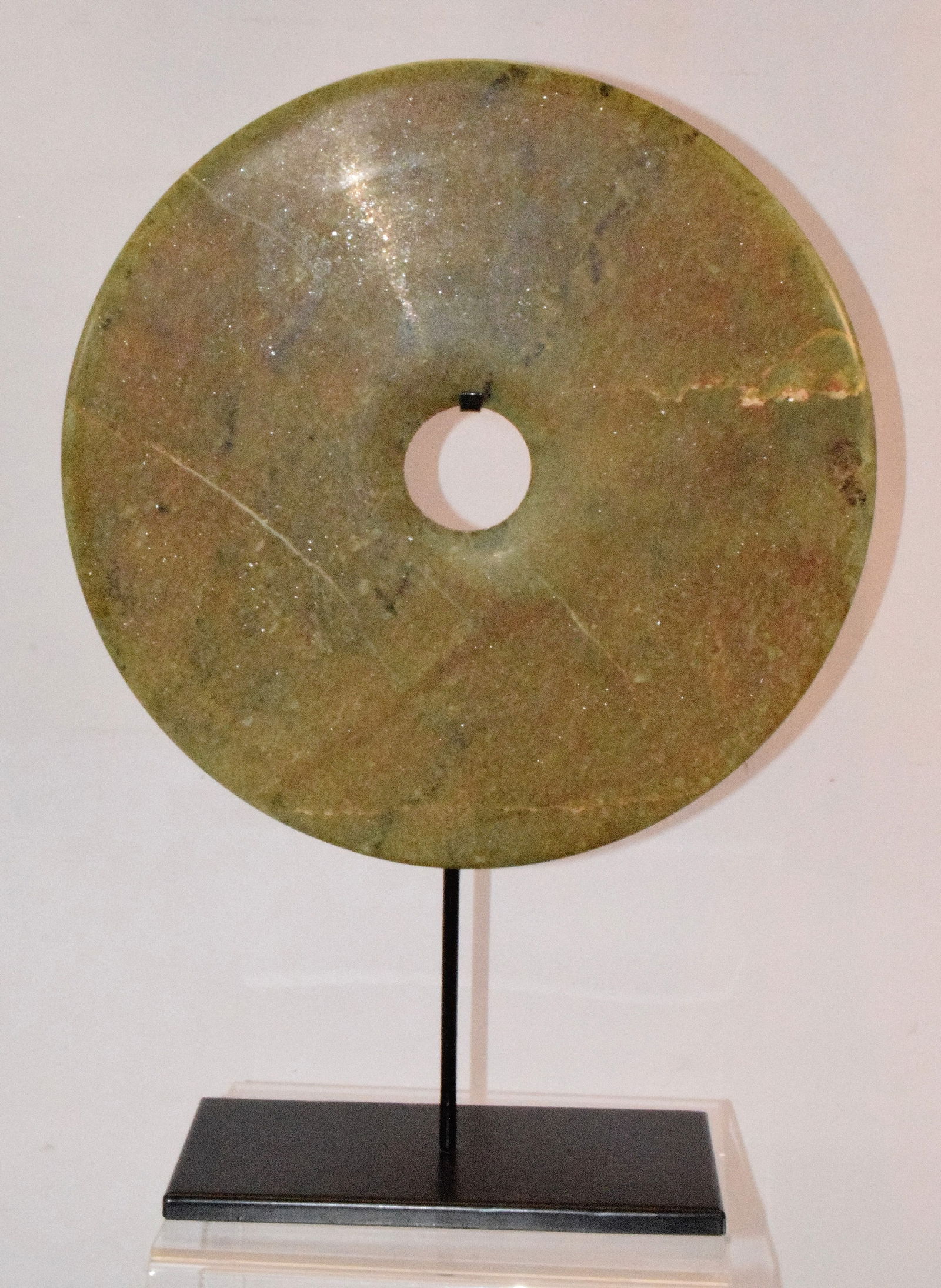 CHINESE JADE BI DISC WITH MOUNT: Large jade Chinese Bi disc in mottled green on metal stand, Good condition. Measures approx. 12 inches (disc). Weighs approx. 5 lbs.