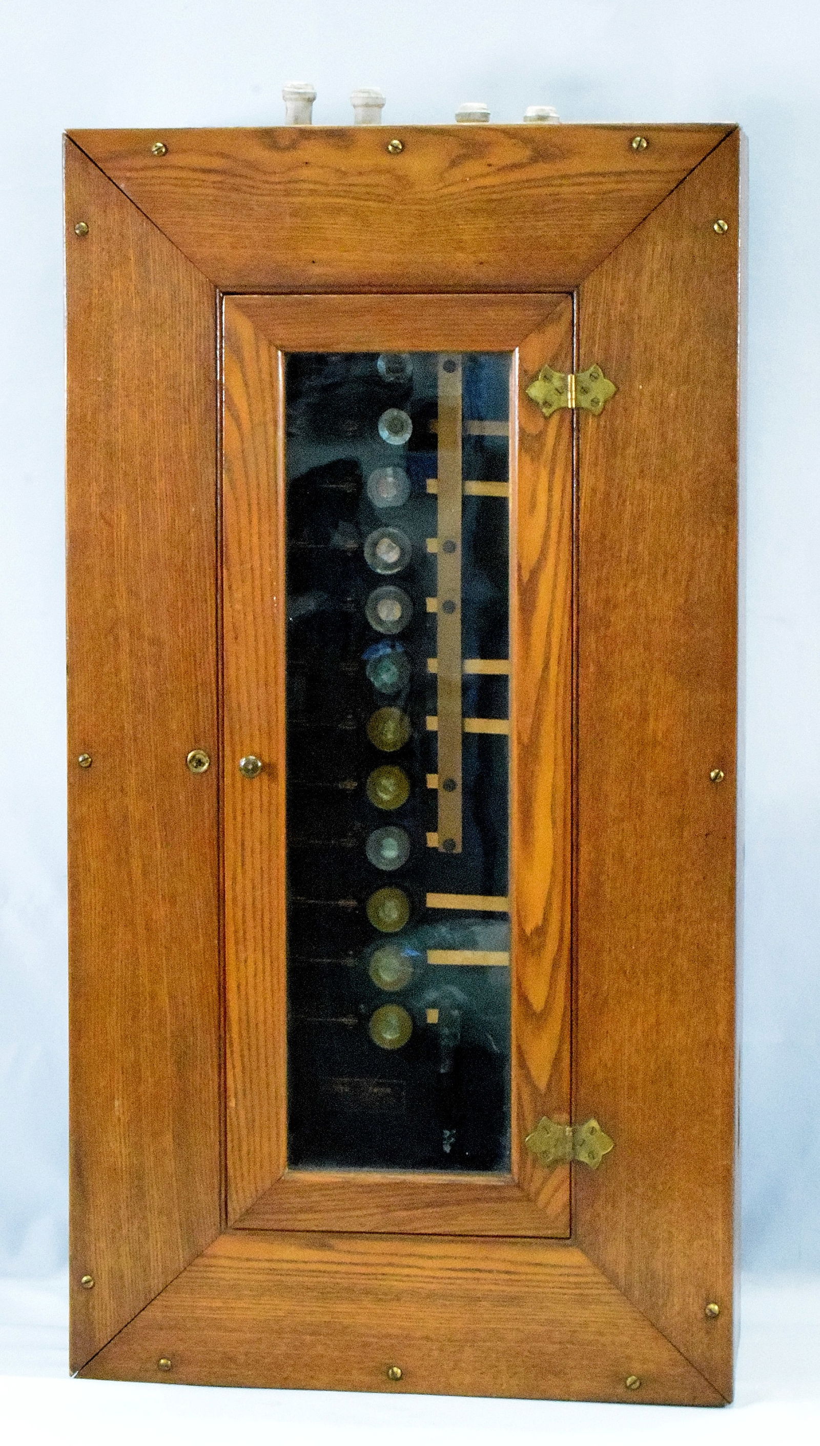 ANTIQUE GENERAL ELECTRIC FUSE BOX CABINET PANEL: Old General Electric oak fuse wall fuse box. Ca 1902. Patent 1893, 1895, Schenectady, N.Y. Encased in large oak cabinet with glass door. Contains 12 fuses (2 missing). Case measures 32 inches x 17 inc