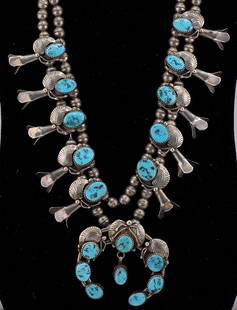 STERLING & TURQUOISE SQUASH BLOSSOM NECKLACE: Navajo sterling silver and turquoise squash blossom necklace, circa 20th century. Good condition. Measures approx. 26 inches long. Weighs approx. 108 grams, 3.47 troy ounces.