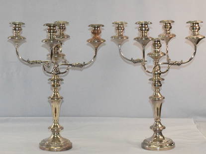 PAIR ORNATE SILVERPLATE 5 LIGHT CANDELABRUM: Ornate silverplate on nickel silver 5-light candelabrum. Round 6 inch base. Four arms around 18 1/2 inch center with repousee decoration. Five bobesses pressent. Base with crown mark andhallmarks. Mea
