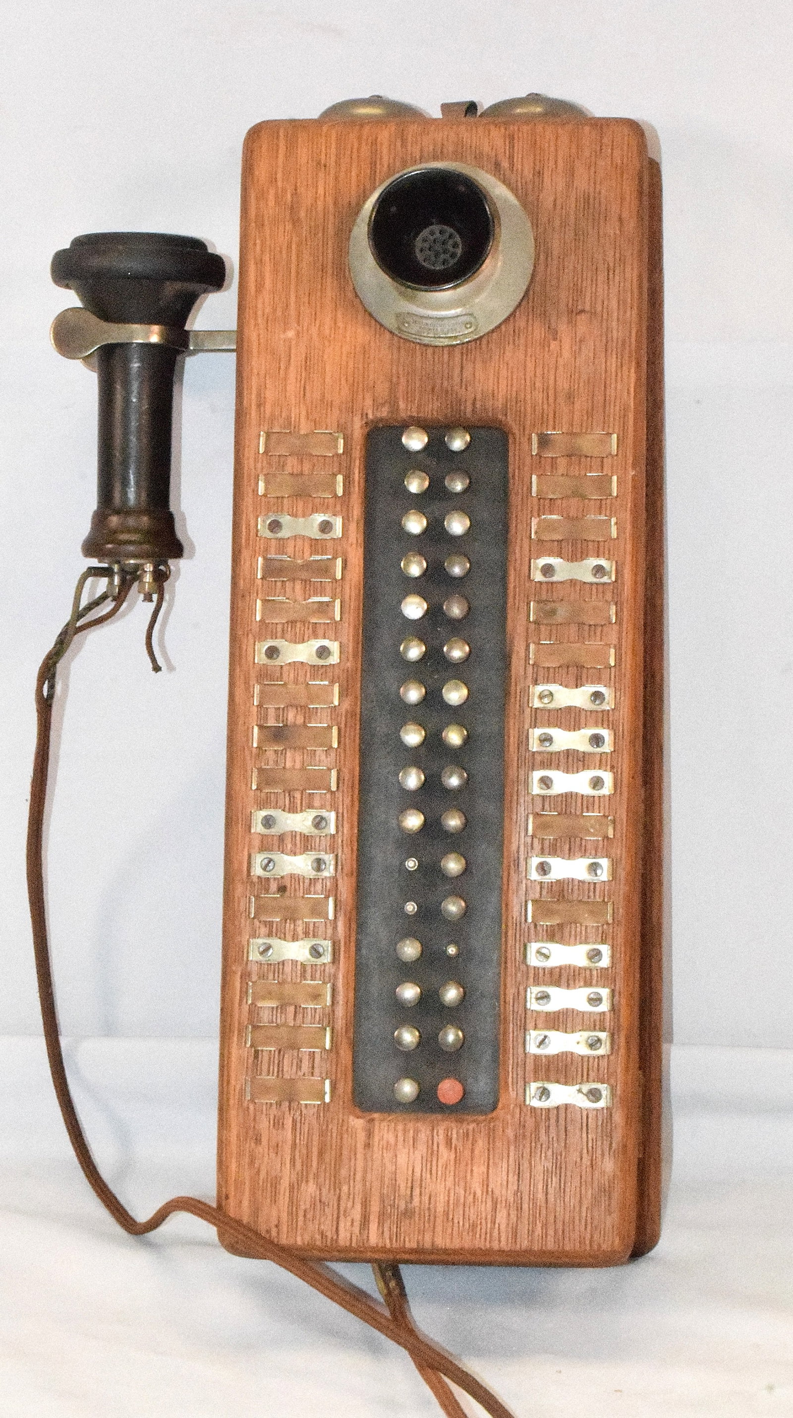 ANTIQUE DEVEAU "INTERTALK" WALL INTERCOM PHONE: Made in 1909, used as a intercom telephone system designed within a building or between different units, made of wood and metal, has 30 buttons still intact, 3 are missing and one is broken. Has a wir