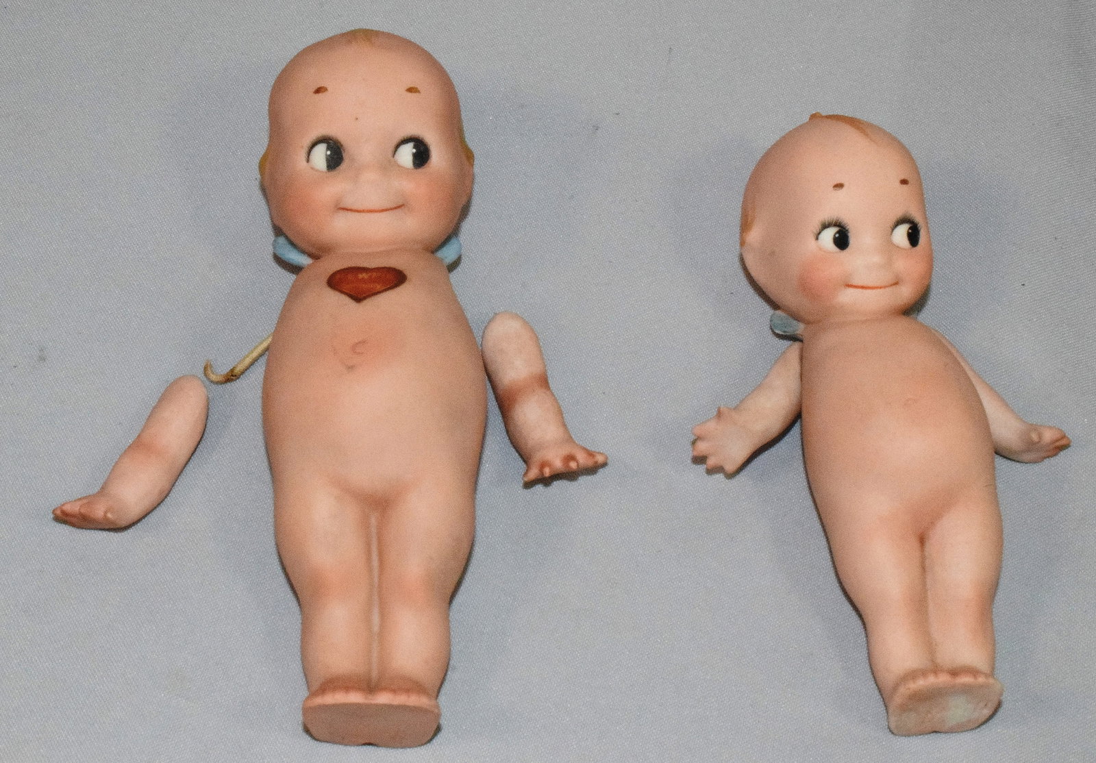 (2) KEWPIE DOLLS: One with arms that need to be re-strung. Tallest 7 inches. All bisque.