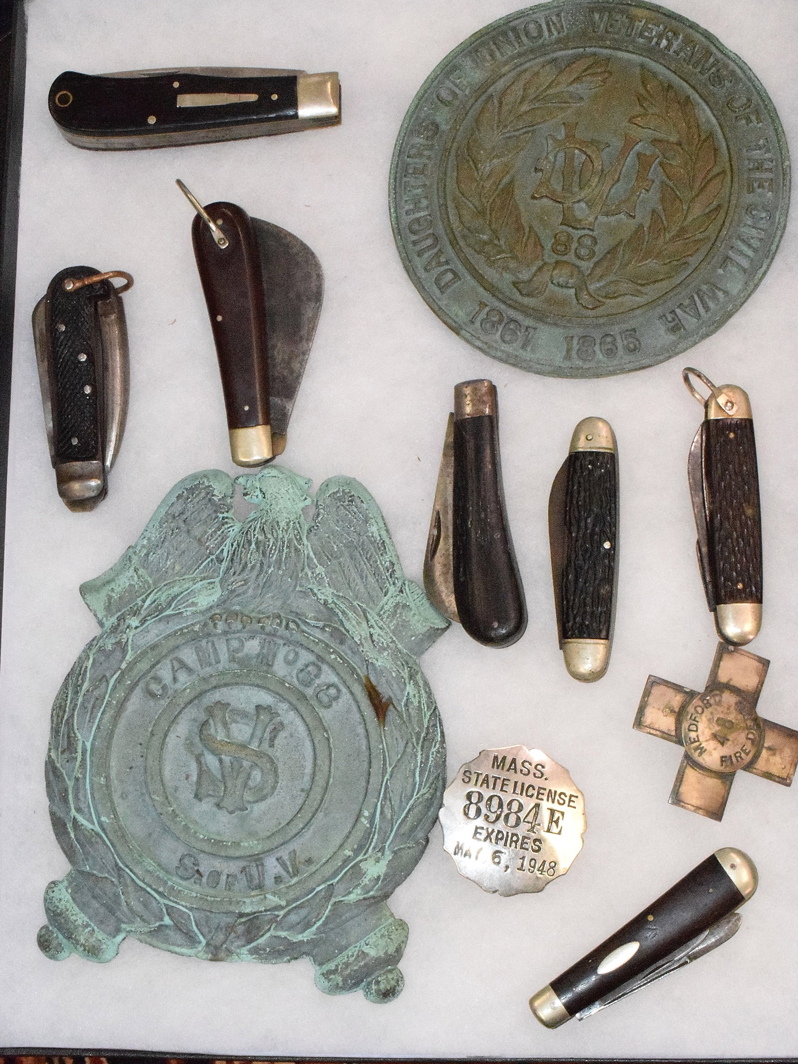 (10) GRAVE FLAG HOLDERS, POCKET KNIVES & ETC: Consists of ten various items. 1) Two civil war era flag holder. Good condition. 2) Seven various pockets knives. Vintage and or Antique. Good condition. 3) Two badges. Massachusetts. Vintage.Good con