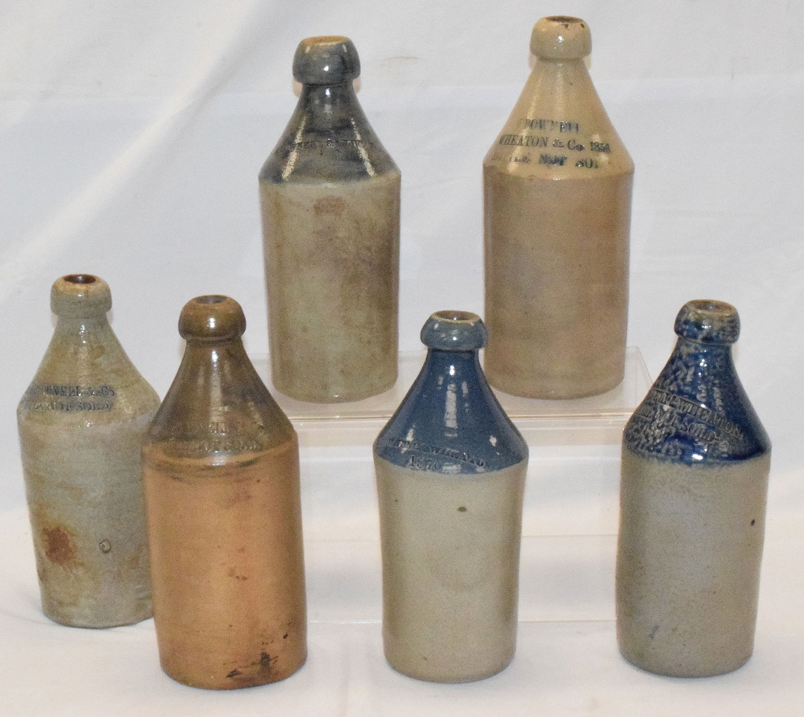 (6) NEW BEDFORD BROWNELL STONEWARE BOTTLES: Collection of six Blue Shouldered Stoneware Beer Bottles by Brownell & Wheaton & co. Brownell & Wheaton & Company 1800's Bottle not to be sold. All show age appropriate wear. 9 1/2" to 9 3/4"high. All