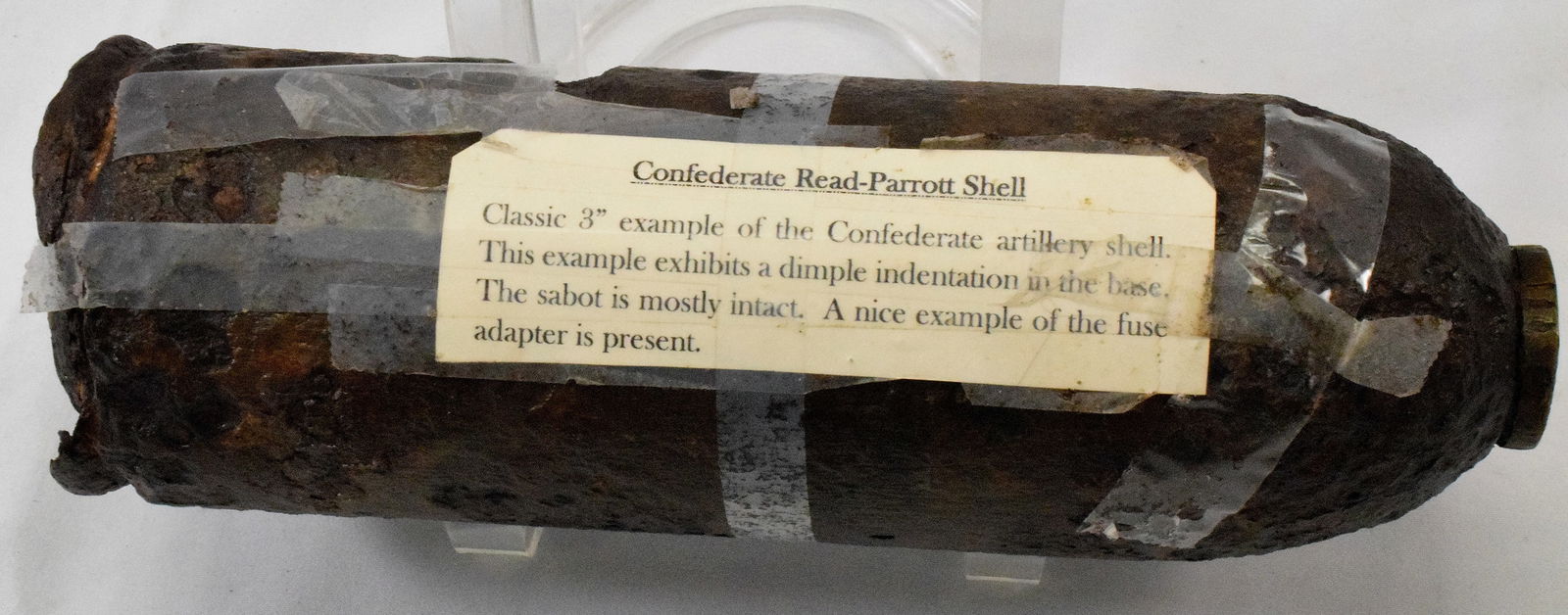RARE CONFEDERATE READ-PARROTT ARTILLERY 3" SHELL: Ca 1860's. Label reads Classic 3" example of the Confederate artillery shell. This example exhibits a dimple indentation in the base. The Sabot is mostly intact. Nice example of the fuse adapter is pr