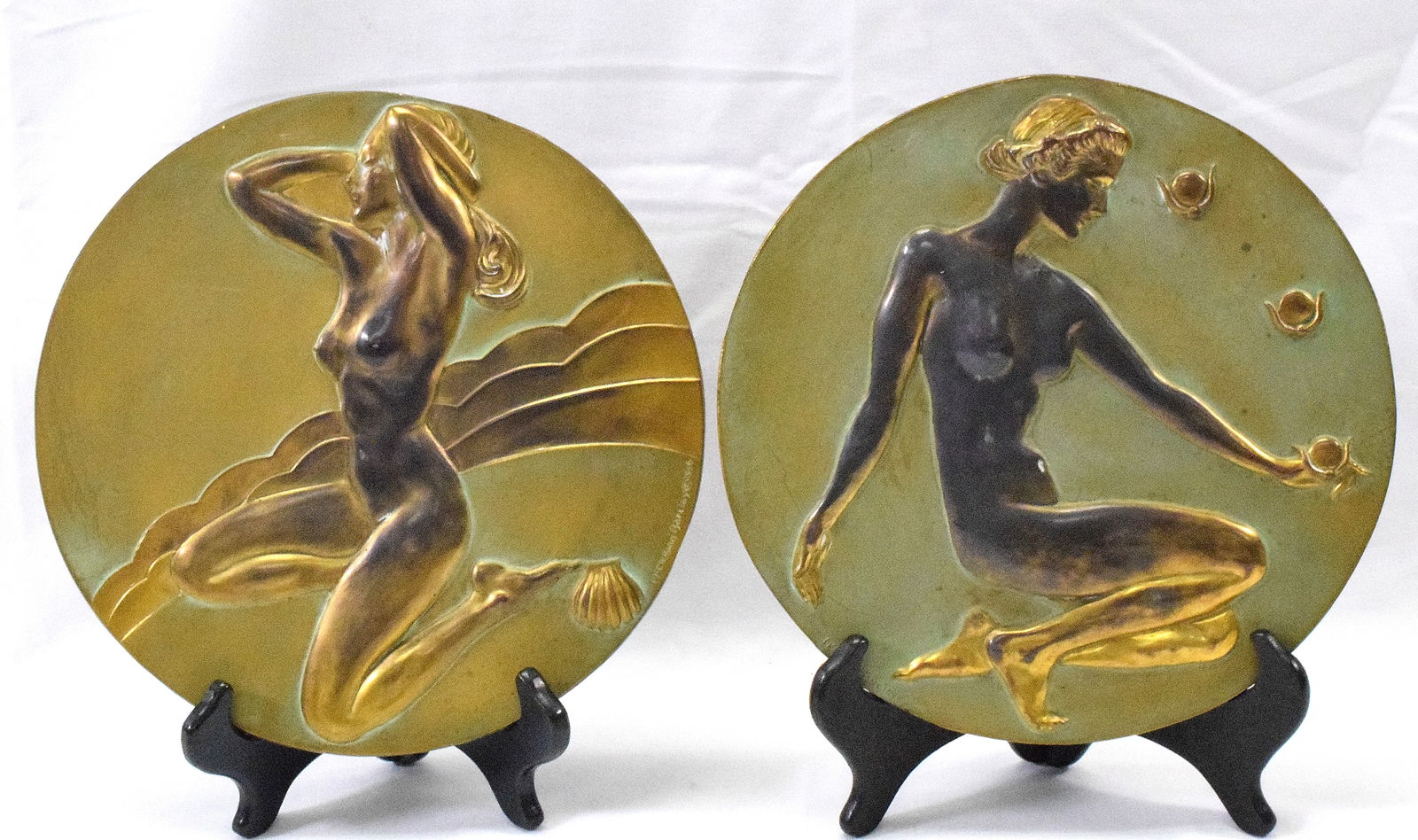PAIR McCLELLAND BARCLAY ROUND BRONZE PLAQUES: 1936 Art Deco McClelland Barclay bronze patina round wall plaques. Both are signed and dated McClelland Barclay (1891-1943). Depicts two Art Deco nude women as Allegories, one kneeling withthree peach