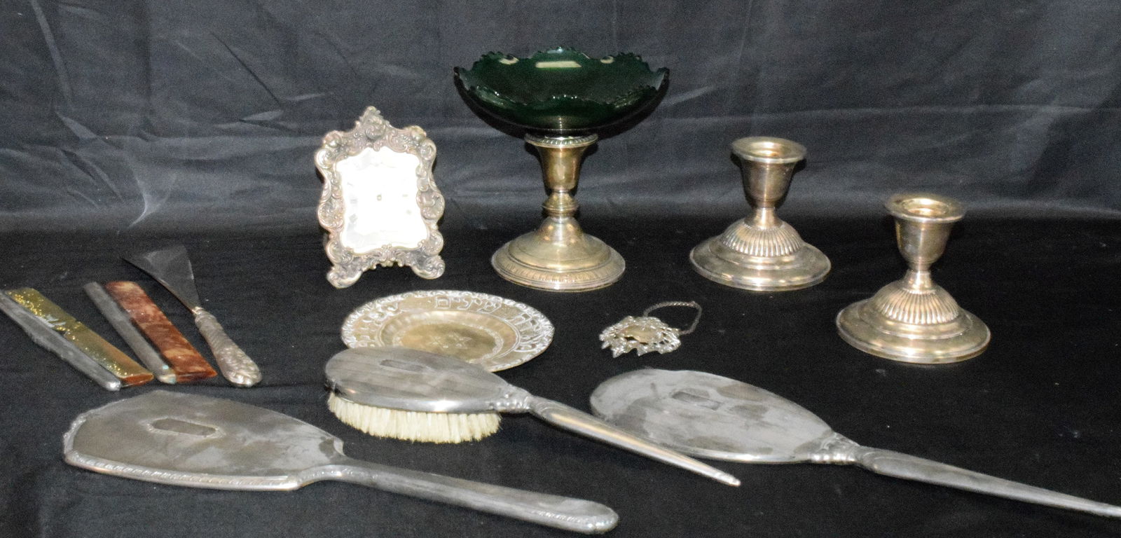 ASSEMBLED STERLING SILVER PIECES: Consists of 1) Weight pair of sterling candlesticks. Maker Fischer. Good condition. 2) 6 sterling dresser hand mirrors, combs, brush and shoe horn. Various makers and conditions. 3)sterling Havdalah p