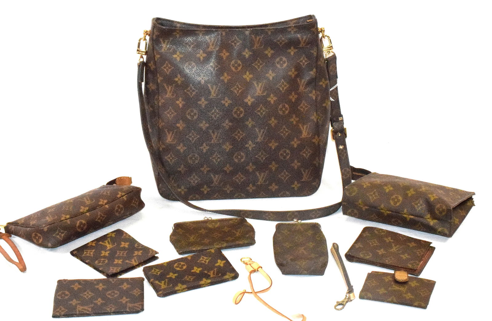 10 LOUIS VUITTON MONOGRAM ACCESSORIES: Large lot of Louis Vuitton monogram accessories. 1) Cosmetic pouch, wrist strap, gold tone hardware. Measures 8 inches wide x 4 1/2 inches high x 1 1/2 inches deep. 2) Cosmetic pouch.Measures 7 inches