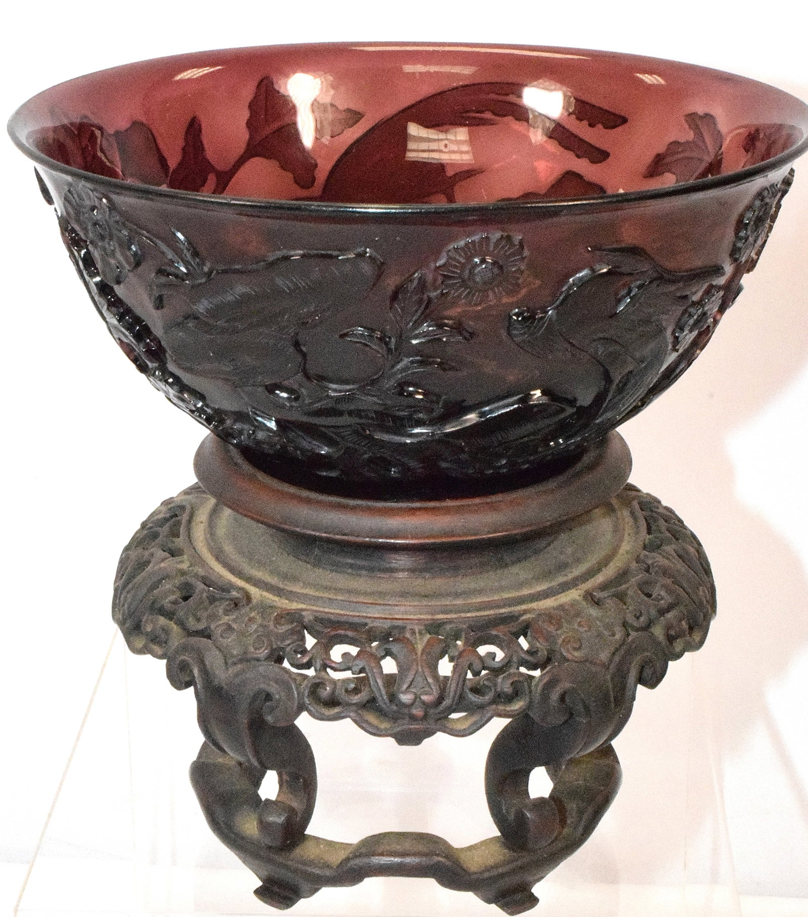 CHINESE AMETHYST CARVED CAMEO GLASS BOWL: Flower and flying phoenix amethyst Chinese bowl. Teakwood stand. Bowl 6 1/2 inches diameter x 3 inches tall. Good condition. Shipping weight approx. 1 pound.