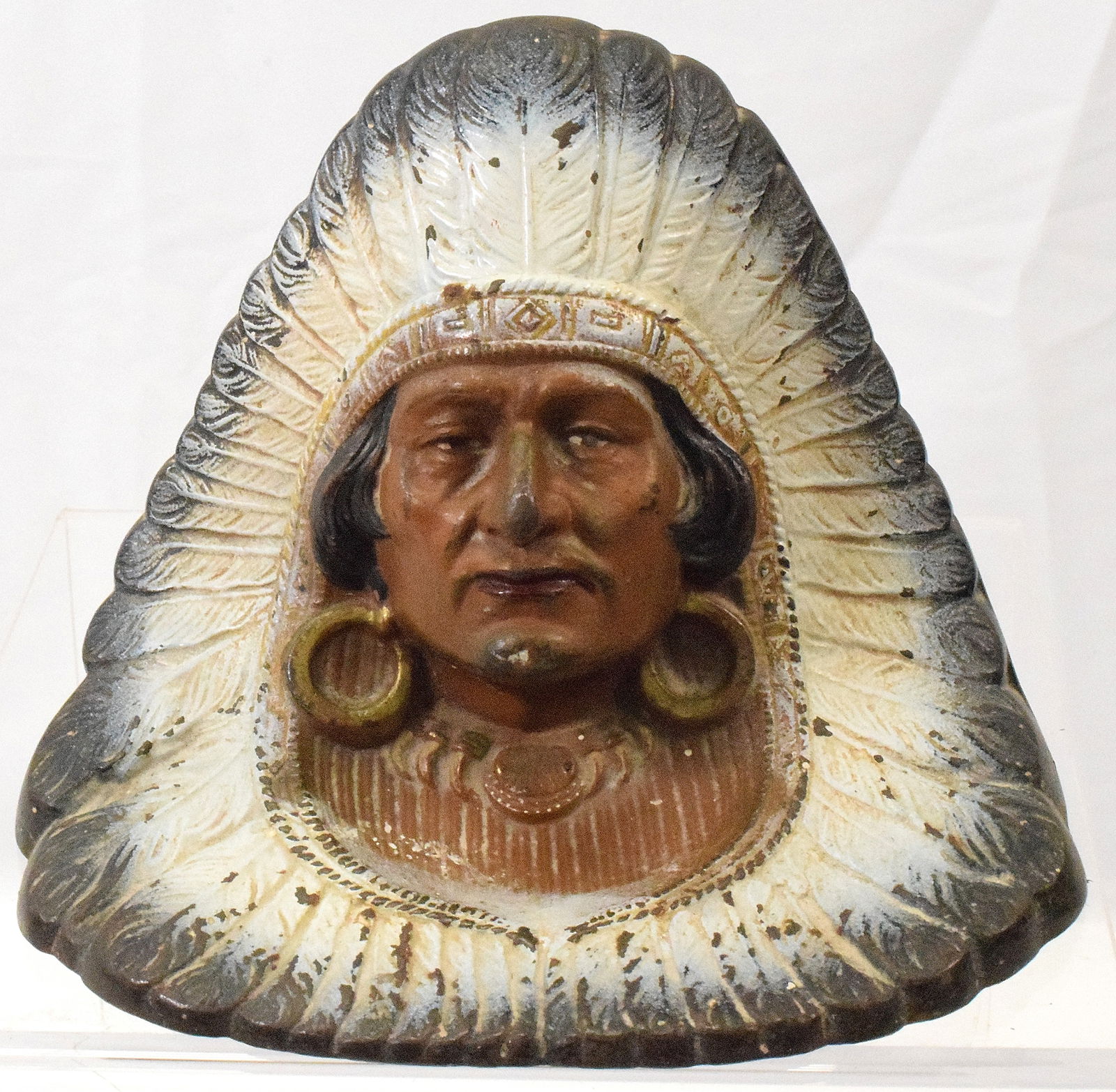 CAST IRON INDIAN HEADDRESS ANTIQUE DOORSTOP: Doorstop with Indian with a full headdress surround. 5 1/2 inches tall x 7 inches wide. Paint is original and bright. Shipping weight approx.