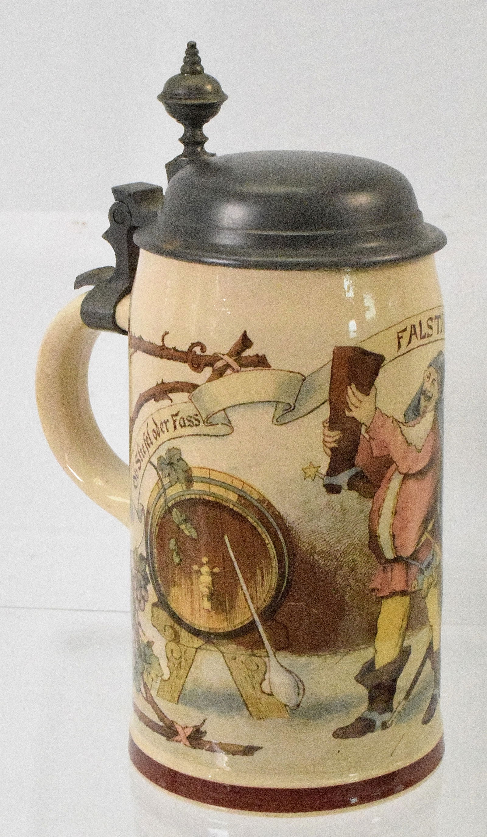METTLACH GERMAN BEER STEIN: 1/2 liter. Pottery transfer with pewter lid. Text "Ob Stiefel oder Fass Falstaff trinkt ex, ohn Spass". Sir Falstaff is one of the most famous comic characters in all English literature,appearing in f