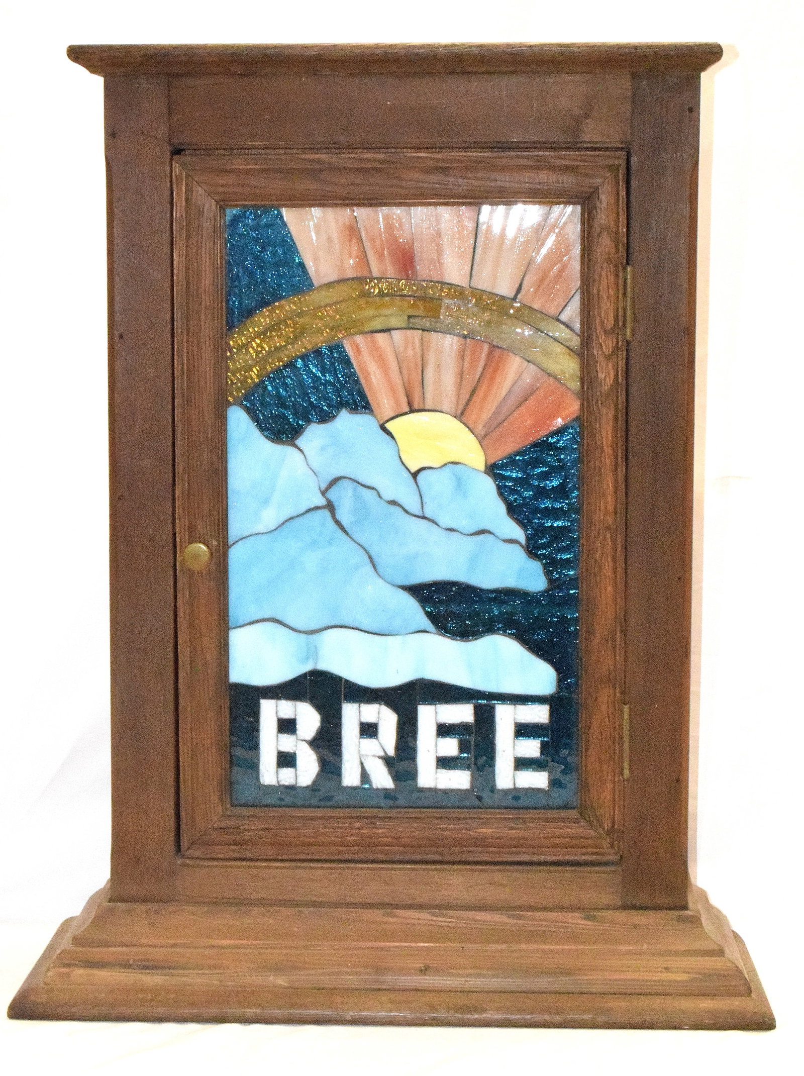 OAK COUNTER TOP LEADED GLASS DOOR: Oak 1900 counter top cabinet with later converted door with leaded glass decoration. Marked Bree. Three interior shelves. 26 inches tall. Bottom cornice 21 inches wide. Shipping weight approx.