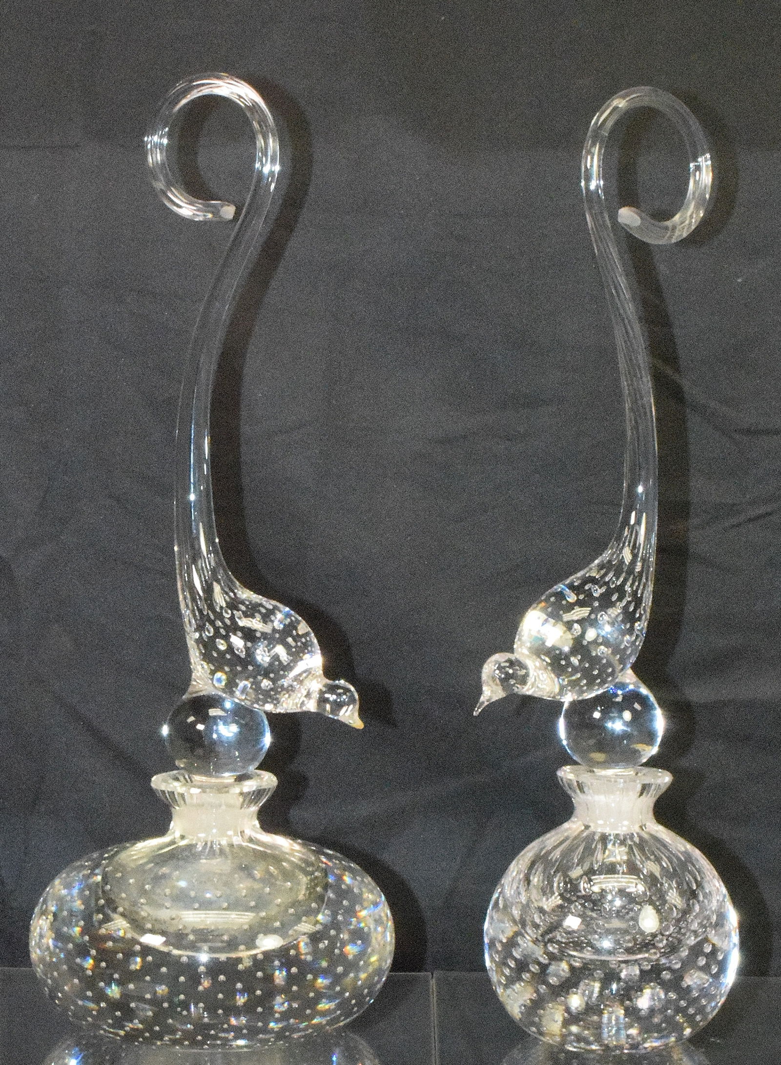 TWO PAIRPOINT FIGURAL STOPPER SCENT BOTTLES: Ca 20th century. Control bubbles. Bird stoppers. Different sizes. 1) Stopper with the birds beak repaired. As is. 12 inches tall) Stopper with chip on fitted end. Visible in photo. Shipping weightappr
