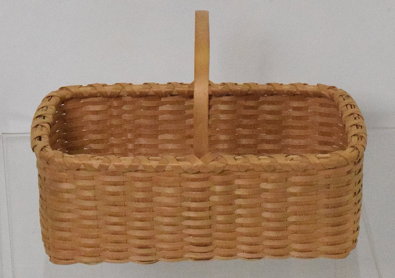 20th TEA BASKET: 20th century tea basket. Rectangular tea basket, made by Stephen Zeh. signed in brown ash on bottom "S.Zeh '89". Good condition. L: 6in, W: 4in, H: 4 1/2in.