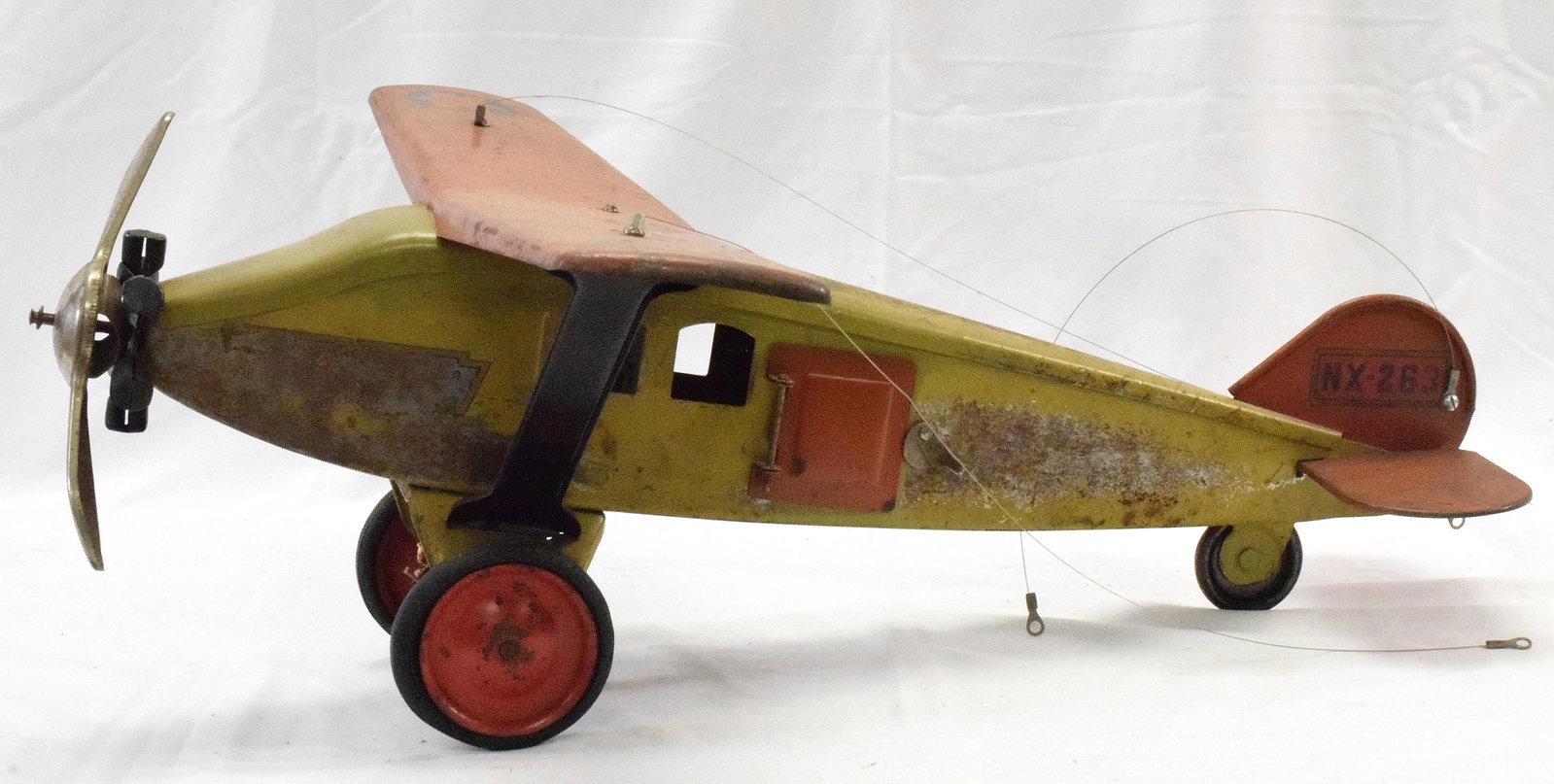 STEELCRAFT PRESSED STEEL LOCKHEED SIRIUS AIRPLANE: Original red and white paint with decals, pressed steel construction. Steelcraft. Circa 1930. 8 1/4" x 21 1/2" x 21 1/2" Some wear and scratches.