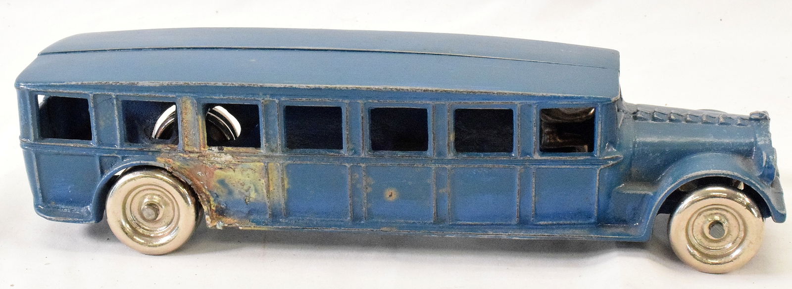 ARCADE FAGEOL SAFETY COACH: 1922 Arcade Manufacturing Company, Freeport, ILL. Cast iron Fageol Safety Coach. Orignal condition in blue. Repair right side rear. Nichel plated wheels and nickel pated driver. Measures 12 1/2inches