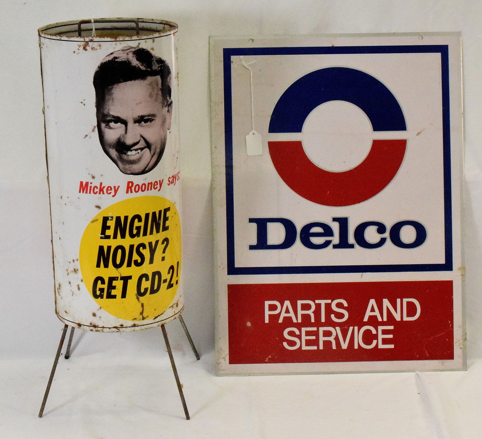 (2) GAS/SERVICE STATION ADVERTISING SIGNS: 1) Mickey Rooney Alemite CD-2 round tin and aluminum cab display. One side with photo image of Mickey Rooney ..."says: Engine Noisy? Get CD-2!".Other side Alemite CD-2 Half Quart Low? Add CD-2. Inside