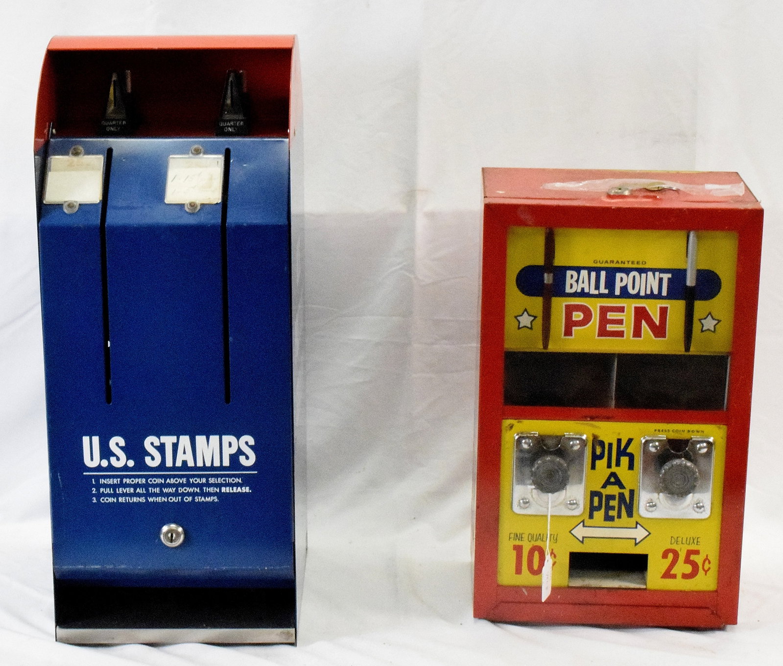 2 VINTAGE COIN-OP DISPENSERS: 1) Coin operated 10 cent and 25 cent pik a pen dispenser. 16 1/2 inches tall. Has key. Good condition. 2) US Postage stamp dispenser. Some minor wear. Good condition. 9 inches wide x 10 1/2 inches dee