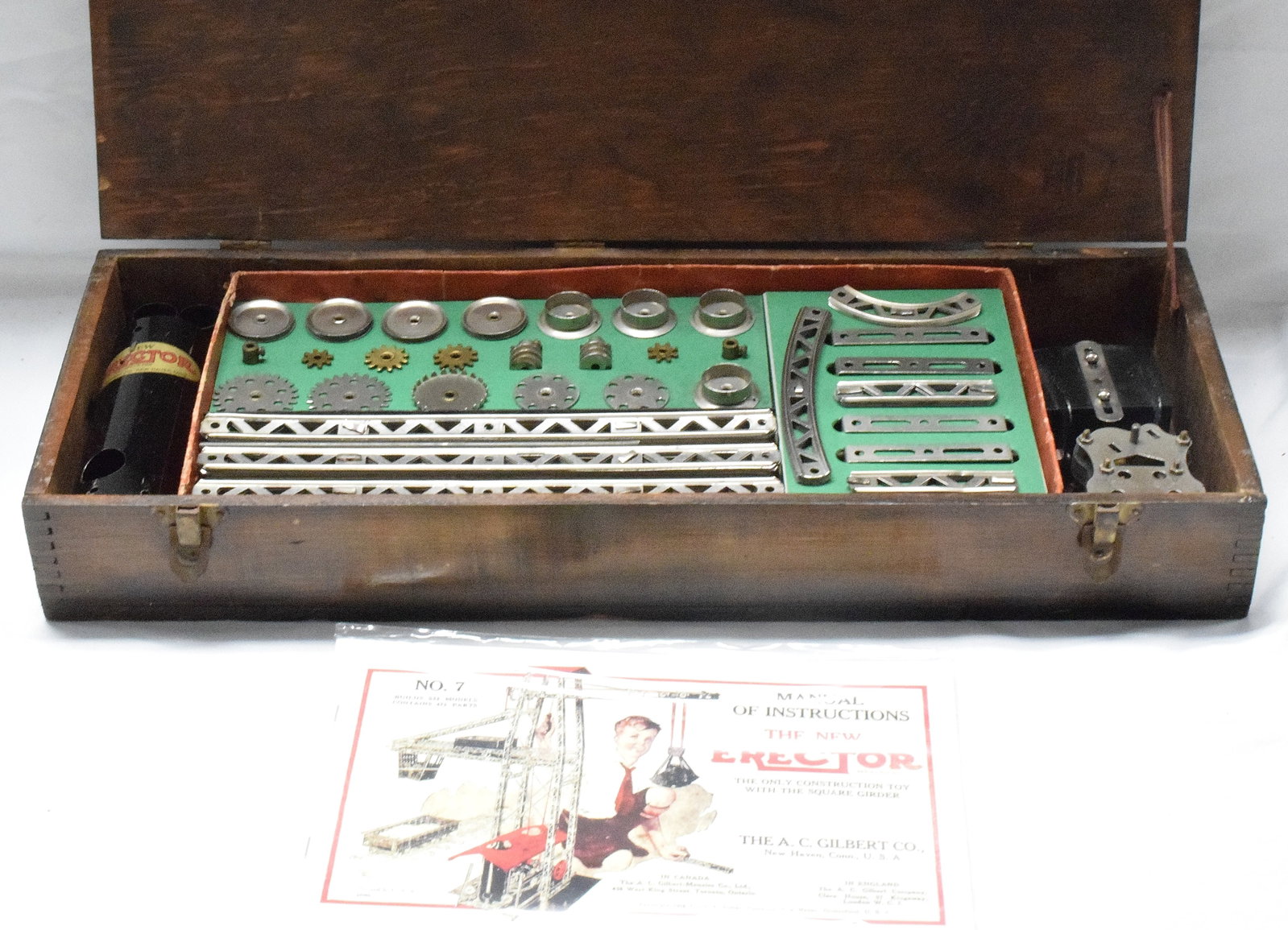 ERECTOR SET #7 STEAM SHOVEL: #7 erector set made by The A.C Gilbert Company in 1926. Steam shuffle wooden box, reproduction parts box, reproduction manual. Good condition. L: 21 1/2in, W: 8in, H: 3in, Weight: 11 lbs
