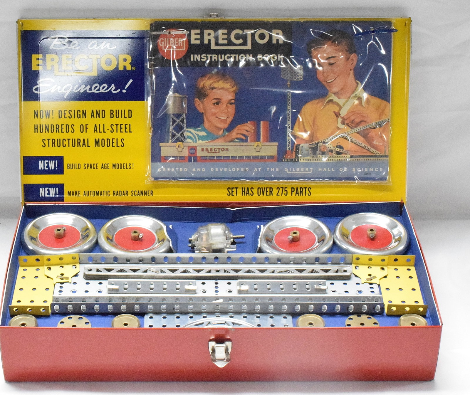 ERECTOR SET SCIENCE CAREER SERIES: Gilbert Erector set, science career series, #10044. Red metal box base with orange and blue litho cover, reproduction tray, builds automatic radar scope. Good condition. L: 16 1/4in, W: 81/2in, H: 3in