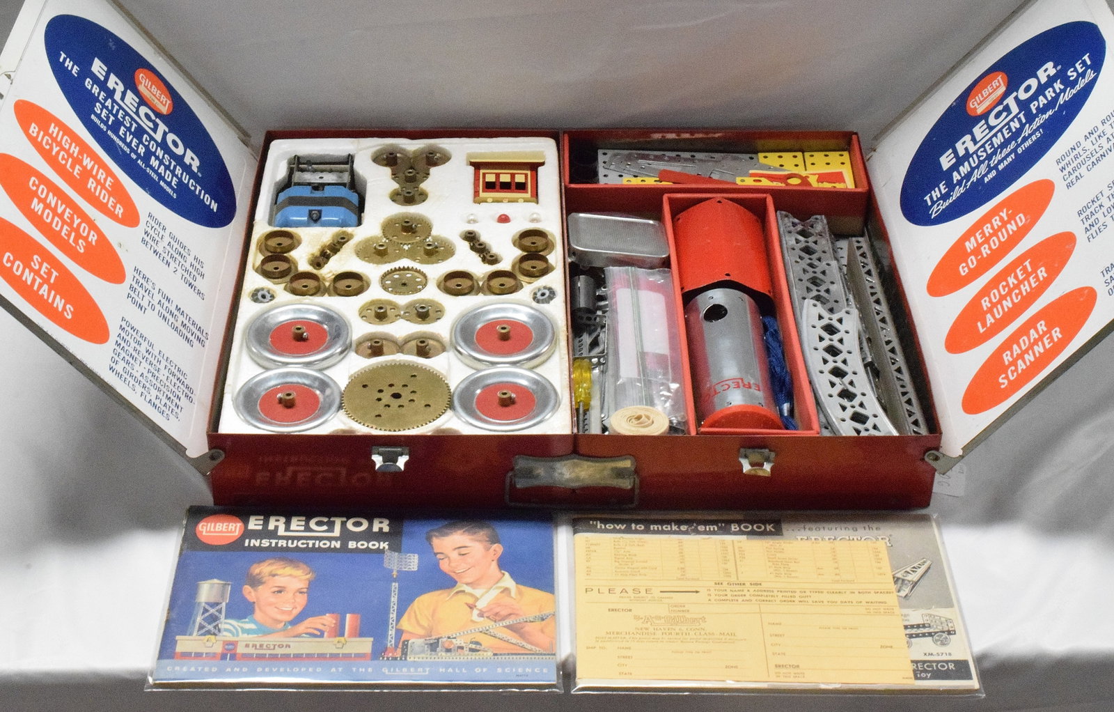 ERECTOR SET #10231 AMUSEMENT PARK: Set #10231, The Amusement Park Set, made by the A.C Gilbert company in 1962. Red metal base with white cover, very early astronaut set. Good condition. L: 20 1/2in, W: 16 1/4in, H: 3in,Weight: 22lbs.