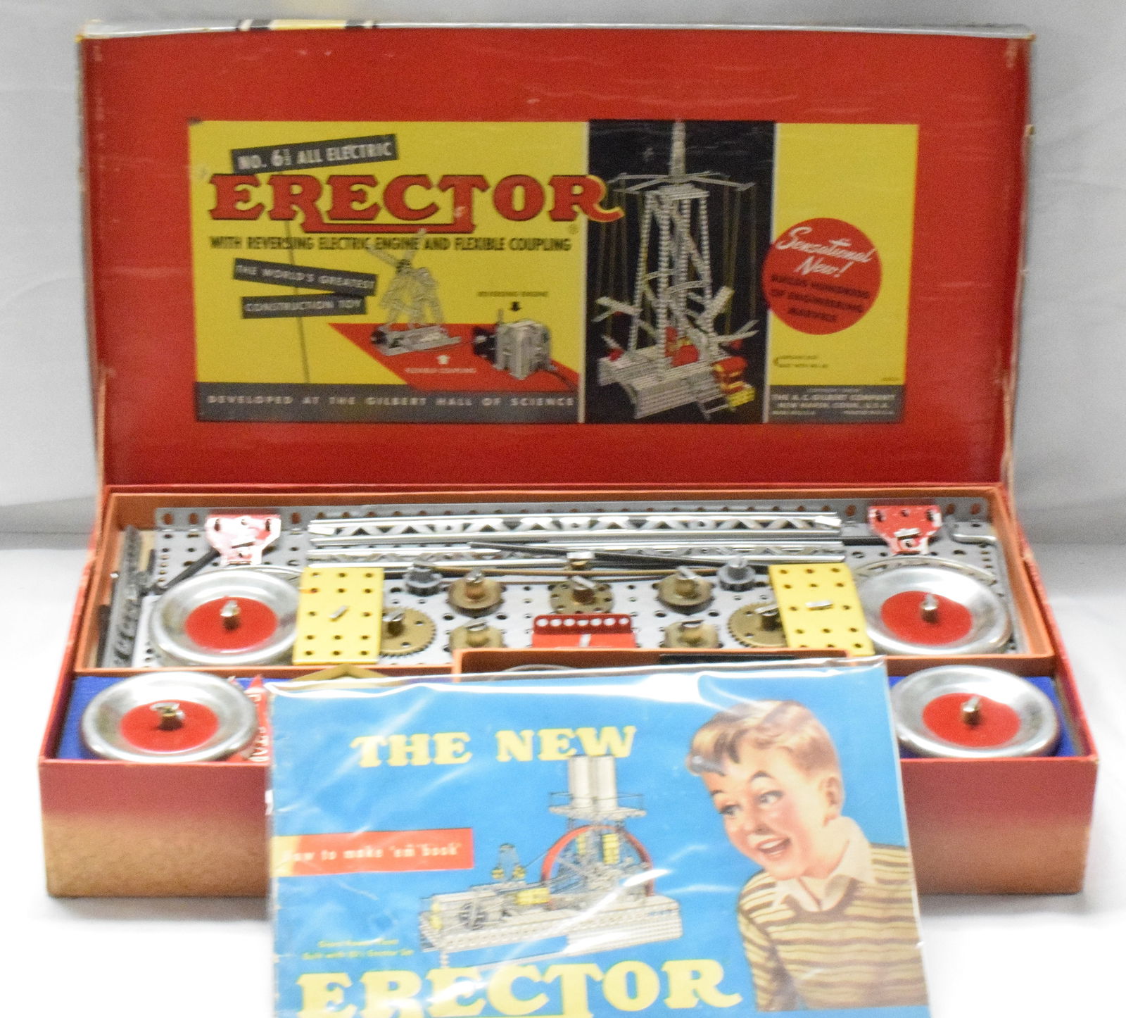 ERECTOR SET #6 1/2 THE ELECTRIC ENGINE: The electric engine erector set #6 1/2, made by the A.C Gilbert Company in 1954. Cardboard box with red base and silver cover, complete set. Good condition. L: 18in, W: 10in, H: 3in, Weight: 8lbs.