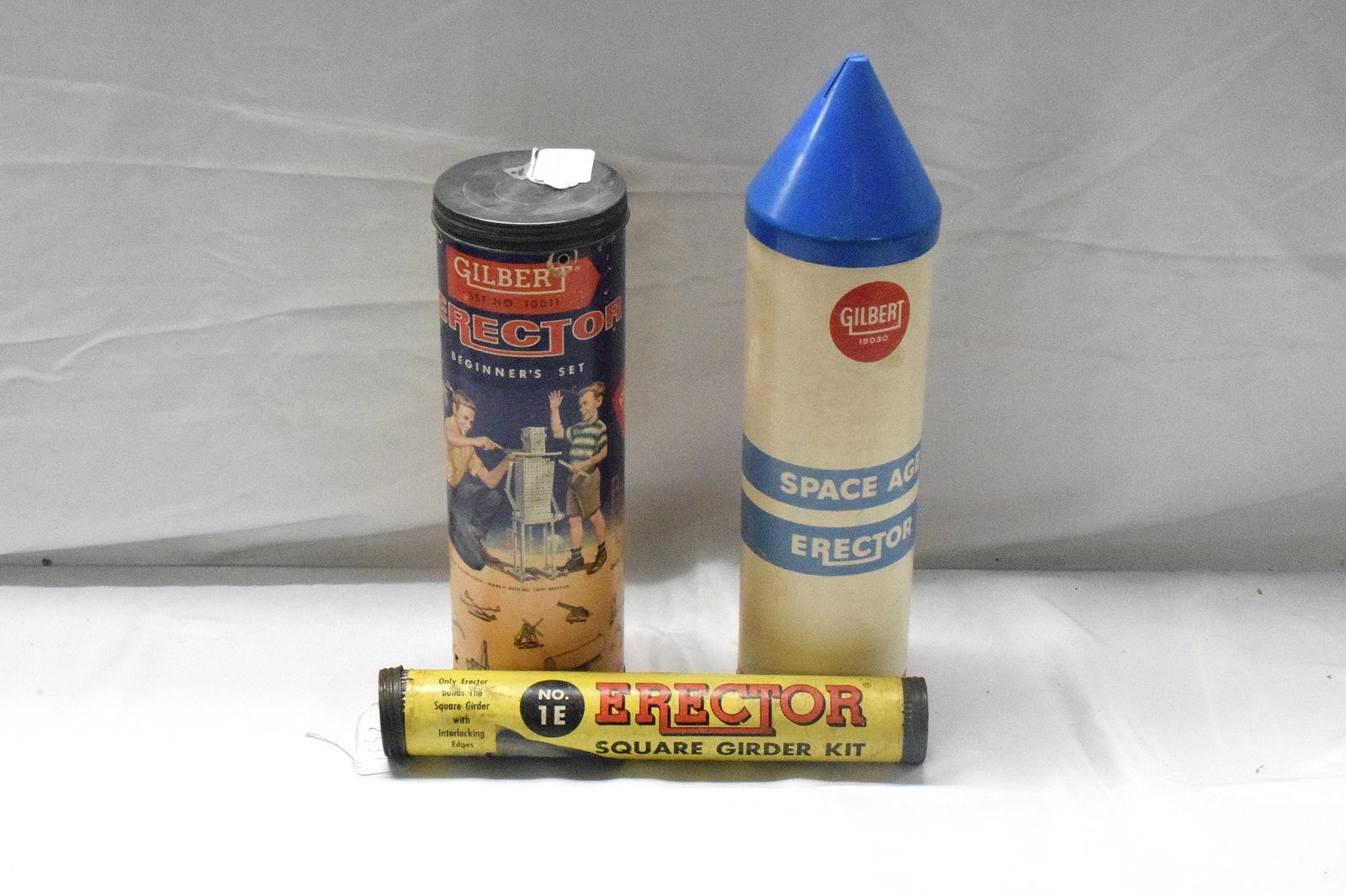 3 ERECTOR TUBE SETS: (1) Pocket erector beginners set, #10011. (2) Space age erector set, #18030, made in 1960, cone shape blue top. (3) Square girder kit, yellow tube. Made by A.C Gilbert company, All goodcondition. L: 9