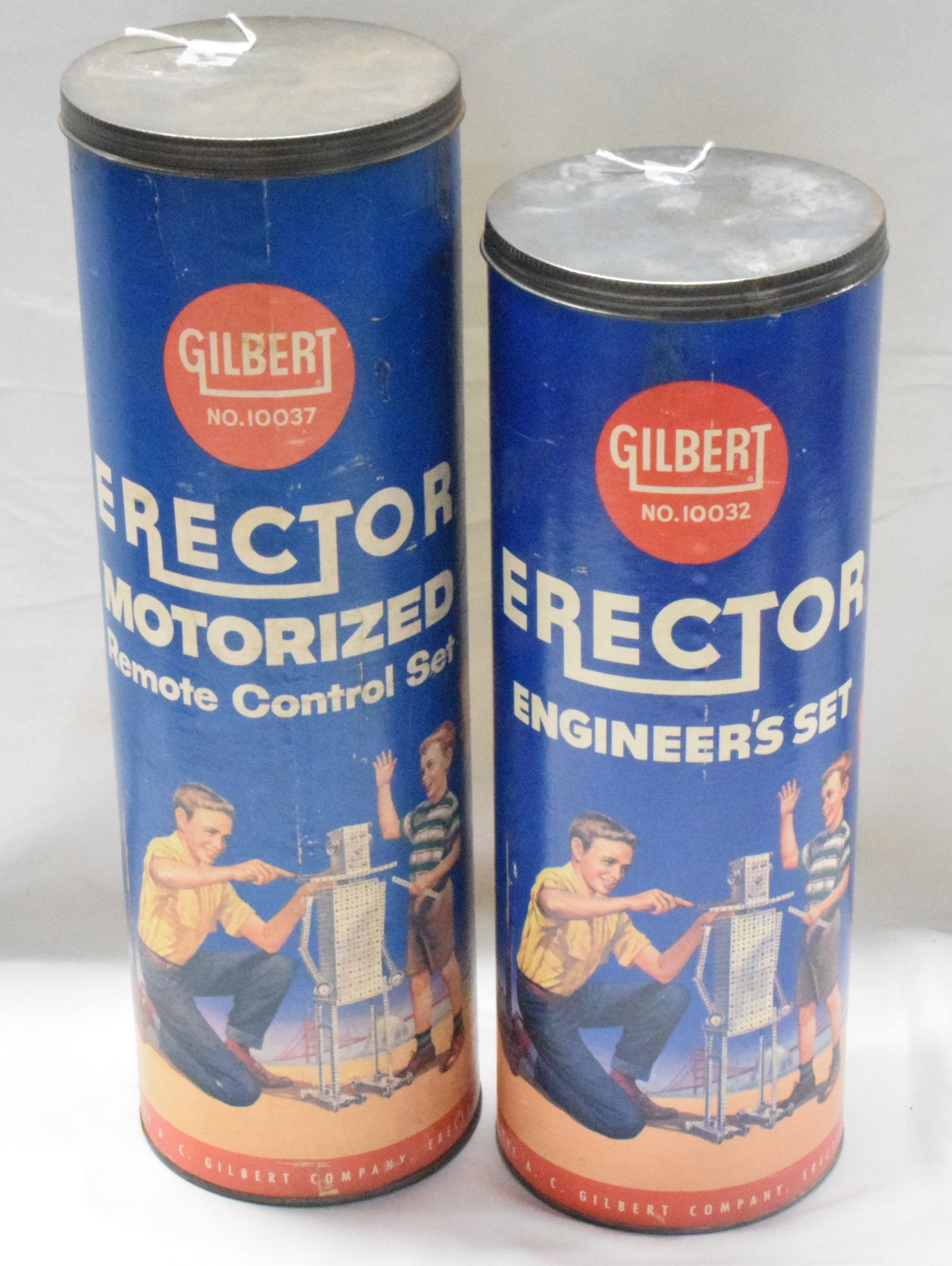 2 ERECTOR TUBE SETS: (1) Erector set #10037, motorized remote control set, blue cardboard tube, complete set. (2) Erector set #10032, the engineers tube set, blue cardboard tube, complete set. Both good condition. L: 10in
