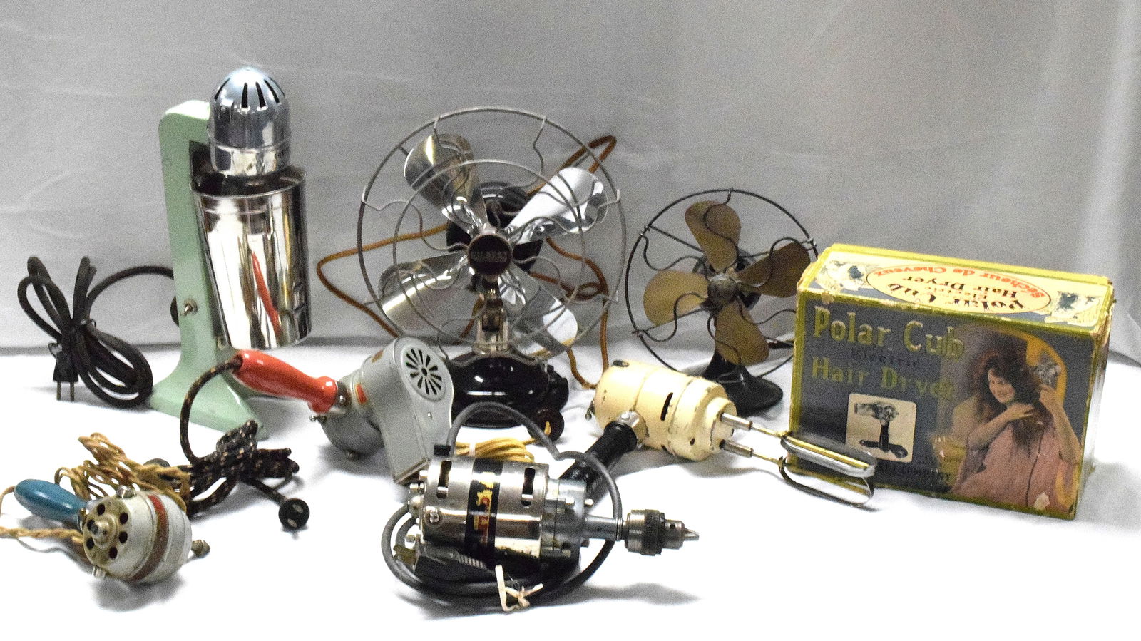 LARGE LOT OF GILBERT HOUSEHOLD APPLIANCES: Milkshake maker, two fans, Two Hair dryer, Vibrator, and electric drill. Items do show age wear and some scratching and paint chips. Various conditions. Items have not each been tested. Asis.