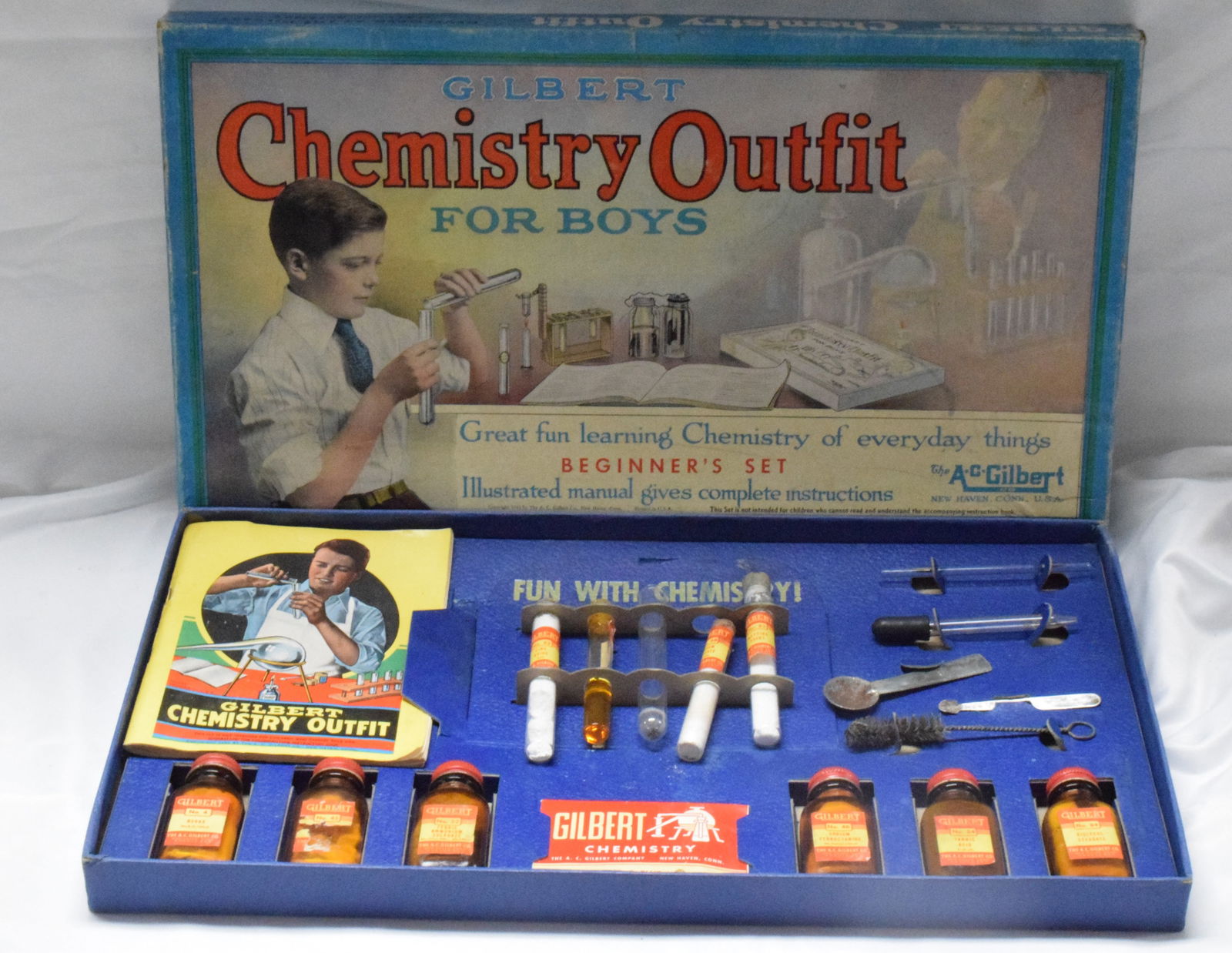 GILBERT CHEMISTRY OUTFIT FOR BOYS: Chemistry beginner learning set for boys made by the A.C Gilbert company. New in box, blue cardboard. Includes original chemicals in vials. Good condition. L; 18in, W: 10in, H: 1 1/2in,Weight 2 lbs.