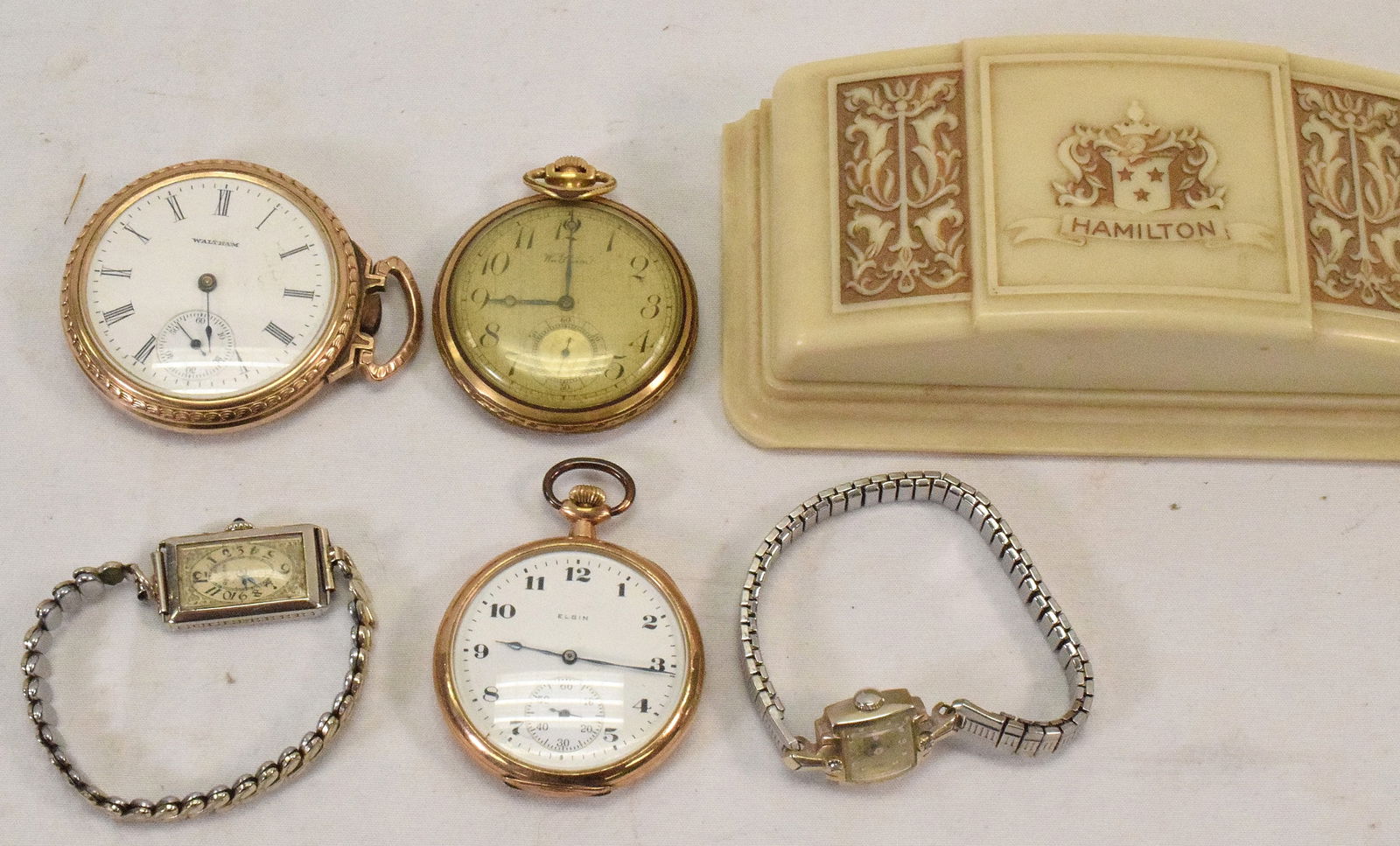 14K WRIST WATCHS & GOLD-PLATED POCKET WATCHES: Mixed assembled grouping of five watches. 1) Lady's Hamilton 14k white gold wrist watch with spidel flex band. Band not gold. Dated 1956. 2) 1927 14k white Gruen lady's wrist watch withspidal flex ban