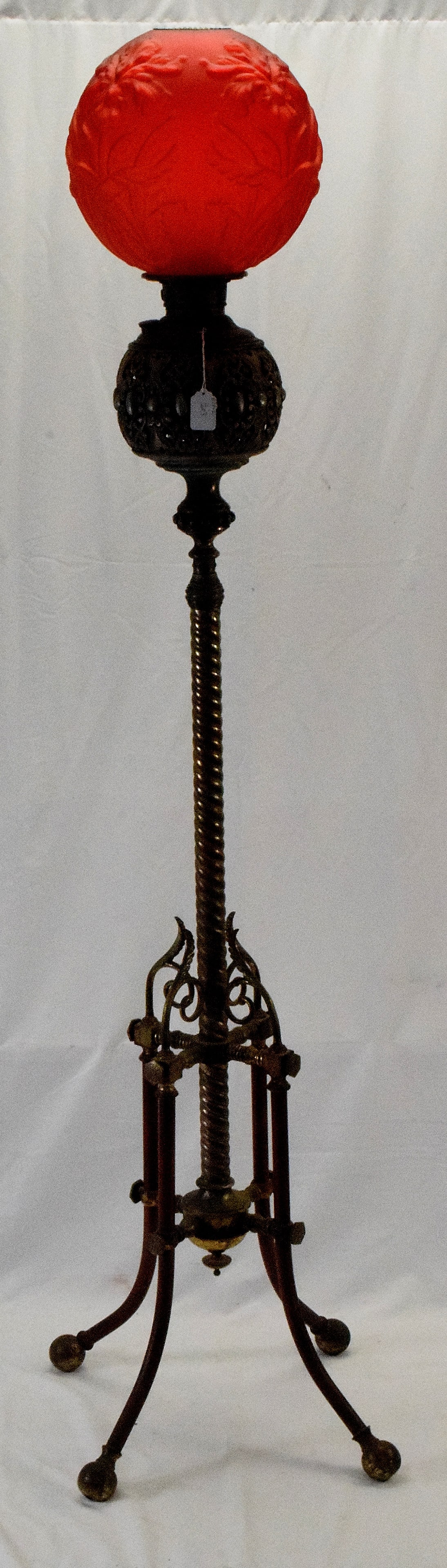 19TH VICTORIAN BRASS PIANO LAMP & RED SATIN SHADE: 19th century part nickel plated brass & brass Victorian piano lamp with floral red satin glass ball shade. Four legged. Red satin ball shade with blown out flowers. Has the brass shade ring. Waselectr