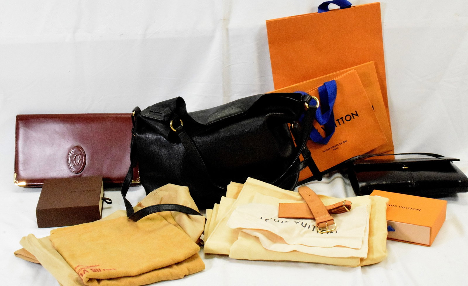POCKET BOOKS, DUST COVERS & LADIES ACCESSORIES: Grouping includes: Ralph Lauren 2 way black leather shoulder bag, dated 1967 on the inside, magnetic closure. Burgundy leather Cartier purse, multiple interior compartments. Black leatherGucci purse, 