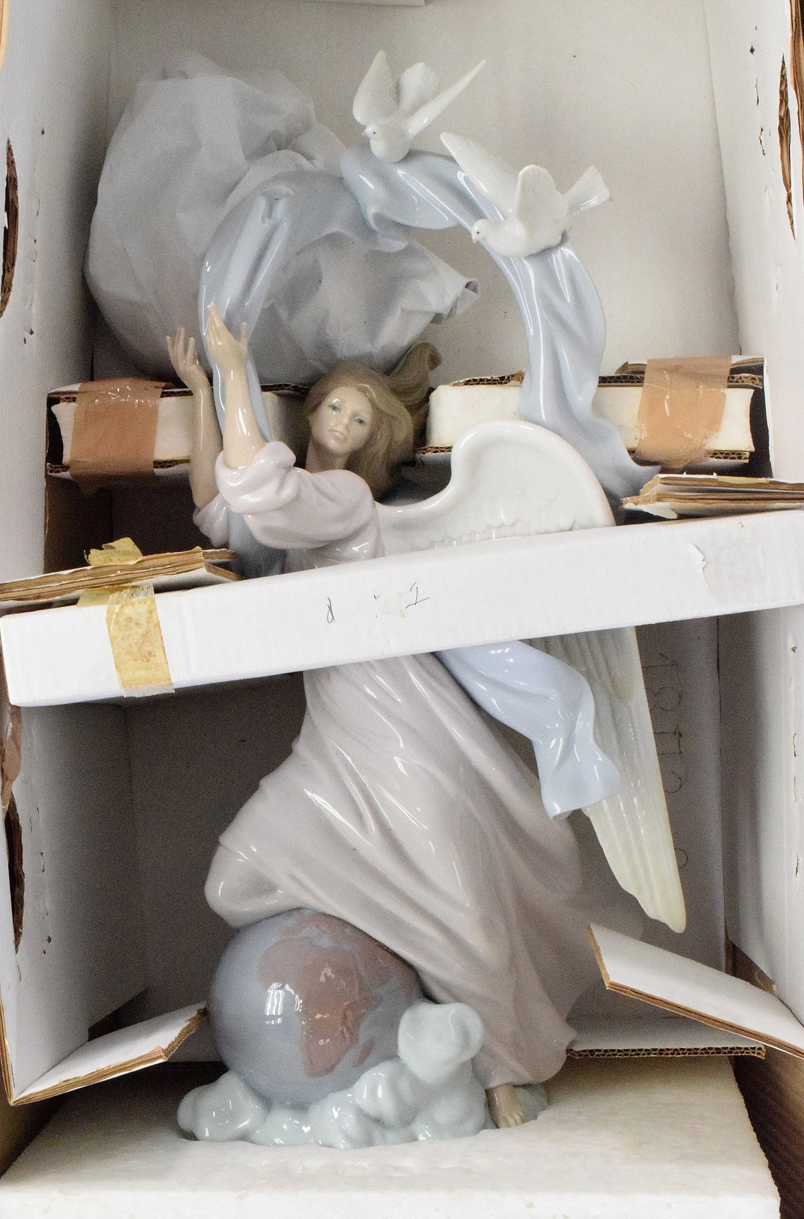 LLADRO #1803 "VISION OF PEACE" PORCELAIN FIGURE: Lladro #1803 "Vision of Peace" figural group. Glazed finish porcelain figure of an angel standing on the Earth and cloud with doves and flowing ribbon above, Spanish name "Angel de laPaz", issued 1995