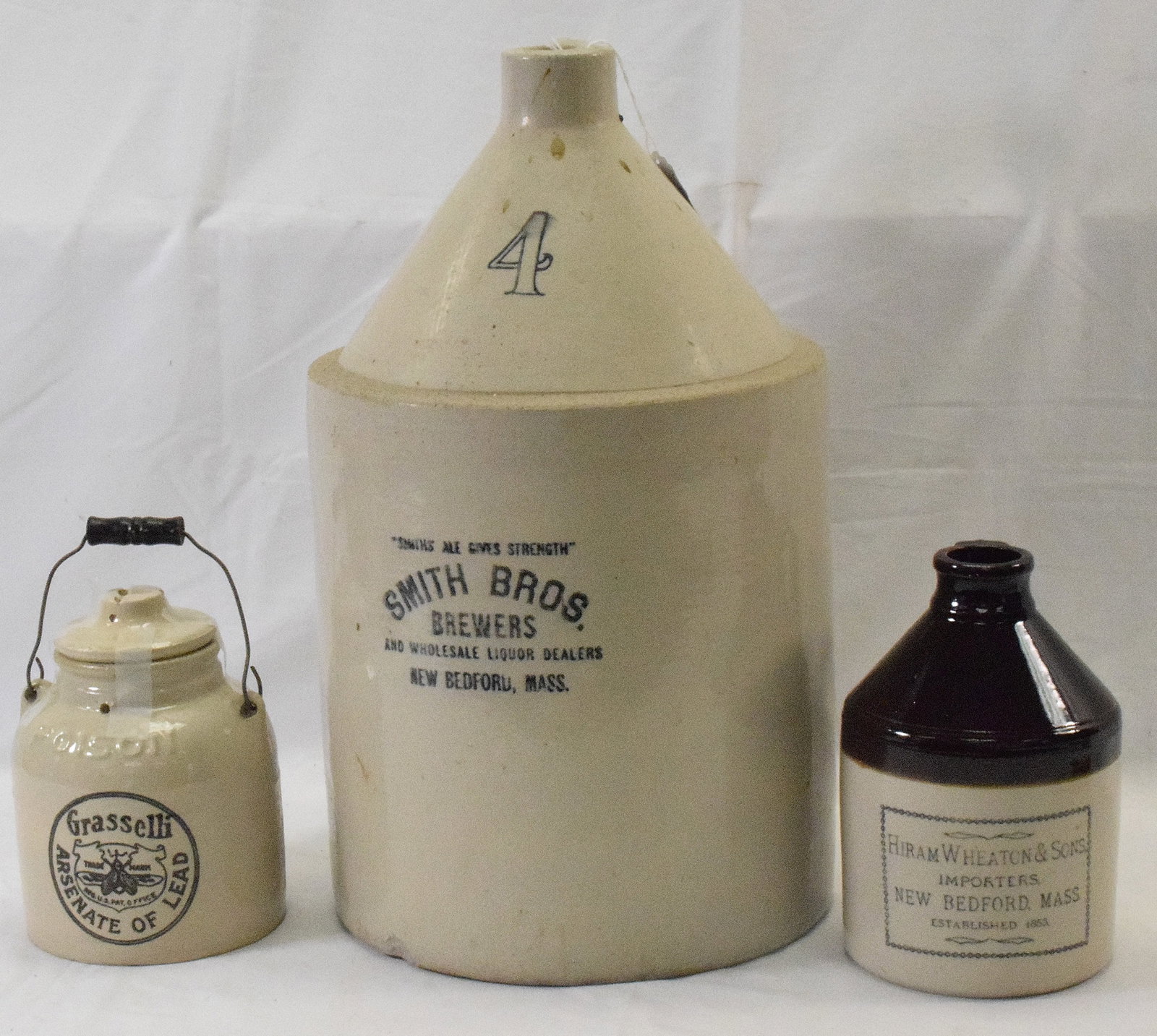 (3) STONEWARE ADVERTISING NEW BEDFORD STONEWARE: 1) Smith Bros. Brewers, New Bedford, MA. 3 gallon, 18 1/2" high, good condition. 4 gallons, " high, Good condition. 2) Grasselli Arsenate of Lead Poison Stoneware Jar.With wire and wood handle,insect