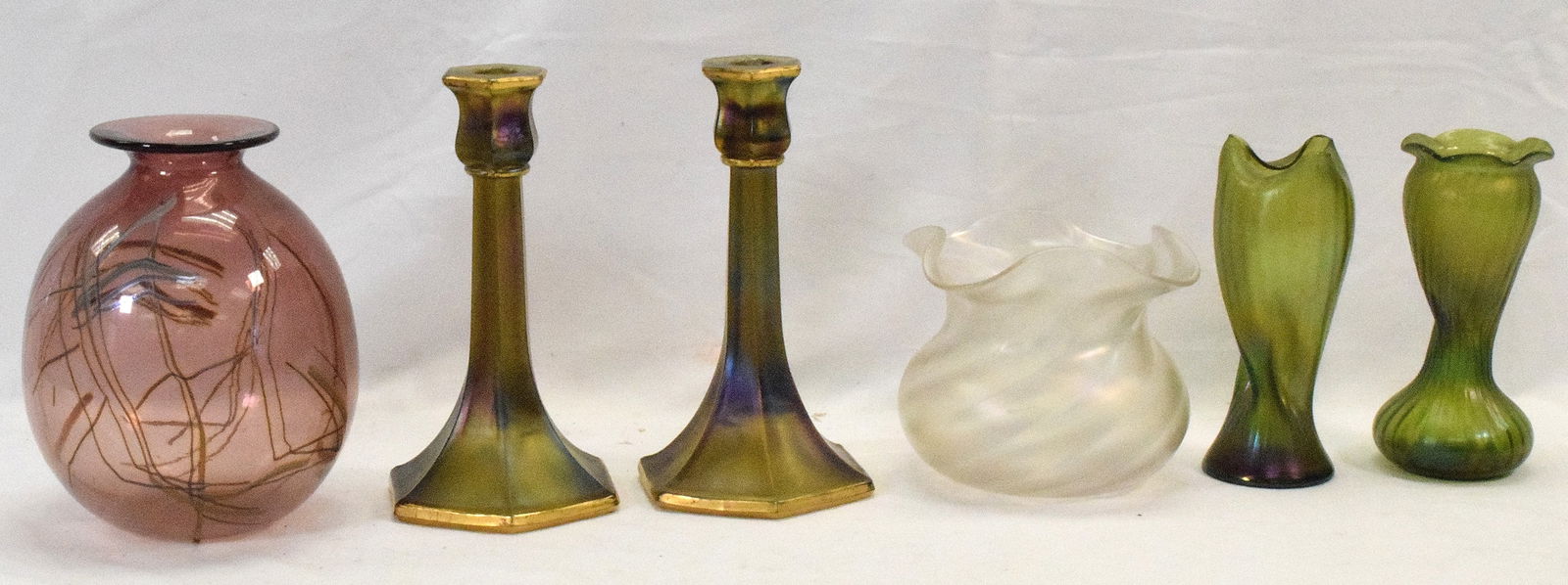 5 ASSEMBLED IRIDESCENT ART GLASS VASES & ETC: Consists of 1) Pair of Depression period iridescent press glass candlesticks. 8 1/2 inches tall. God painted rim and base accents. Minor wear. 2) Daniel Elder studio Graffiti Series artglass vase. 7 1