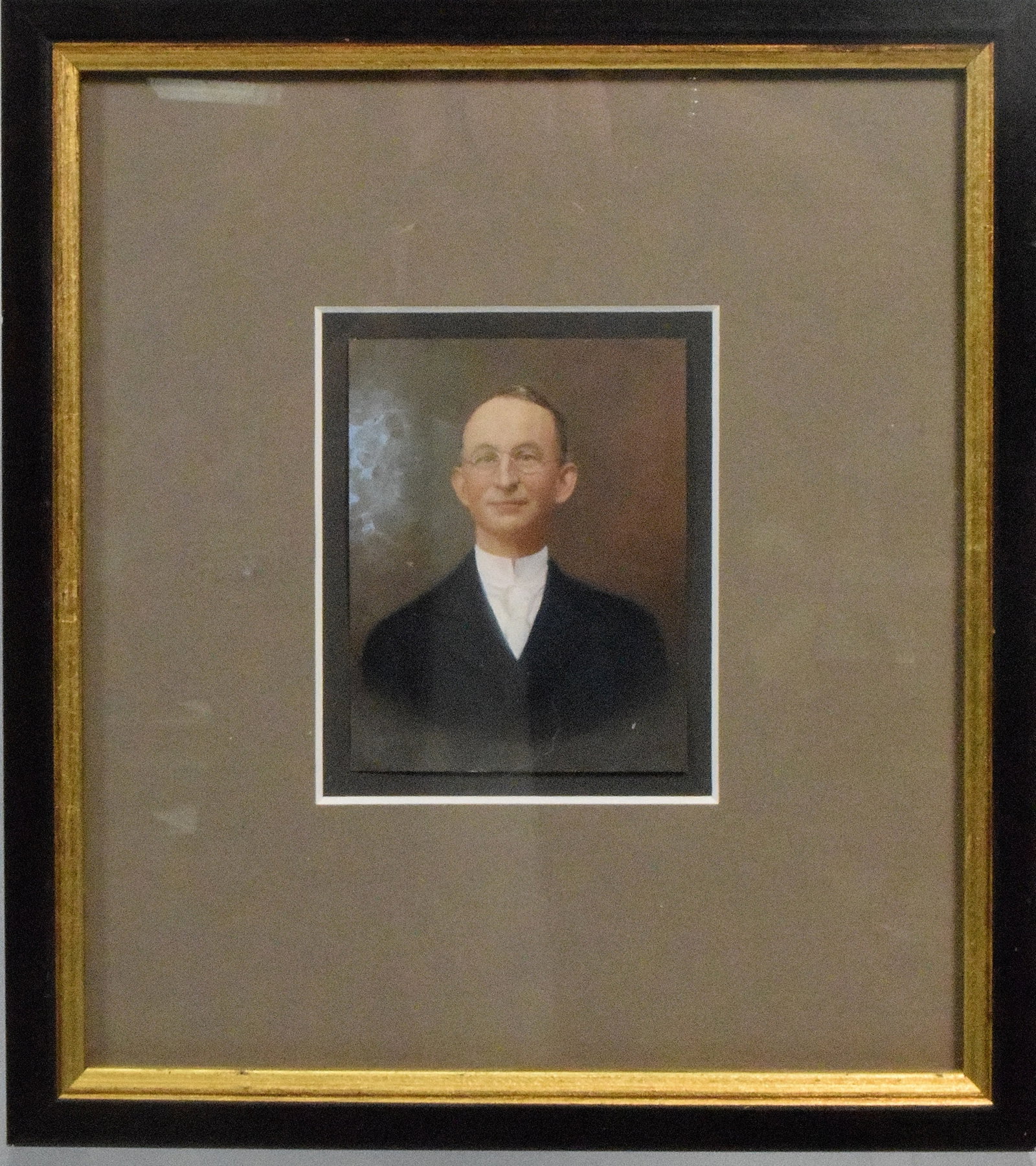 MINIATURE PAINTING ON PAPER: 19th/20th miniature painting on paper. Man wearing glasses Image 3 1/4 x 2 3/4 inches. Framed and matted under plexi-glass. Frame 8 3/4 x 8 inches. Unsigned. Good condition. The Estate of