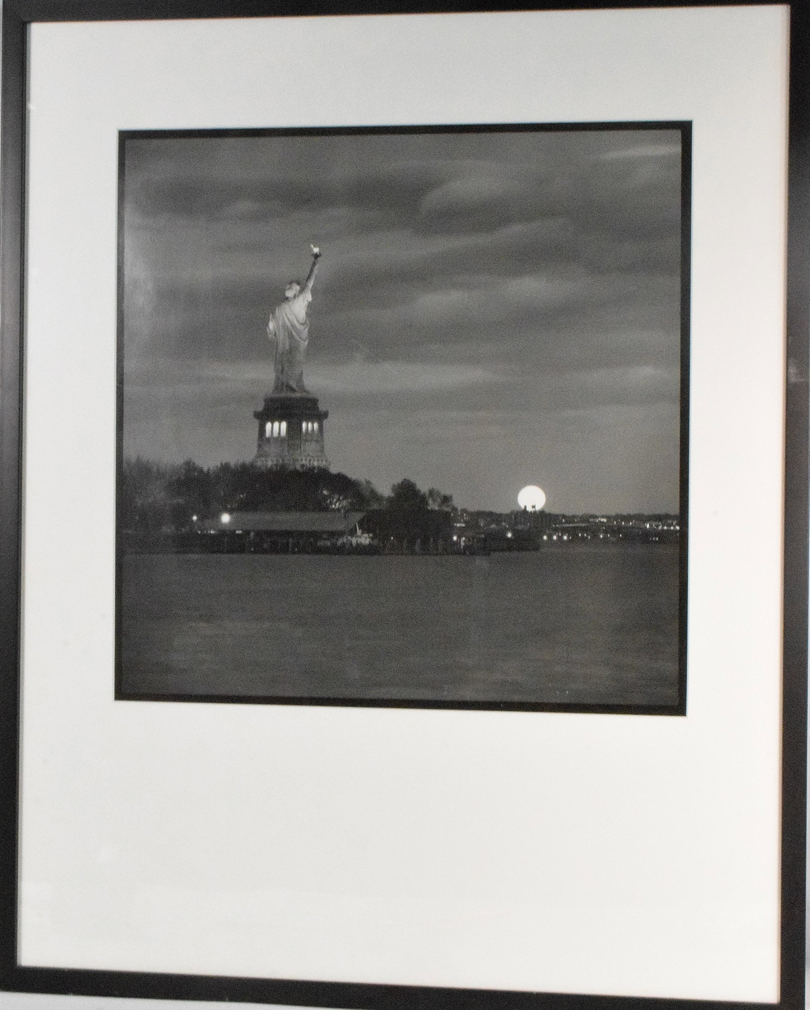 PHILLIP JONES (20th century) PHOTOGRAPH: Phillip Jones (20th century) Titled Moonrise over Brooklyn NY edition 5/45. Image 18 inches x 17 inches. Framed and matted under plexi-glass. Frame 31 inches x 25 inches. The estate of