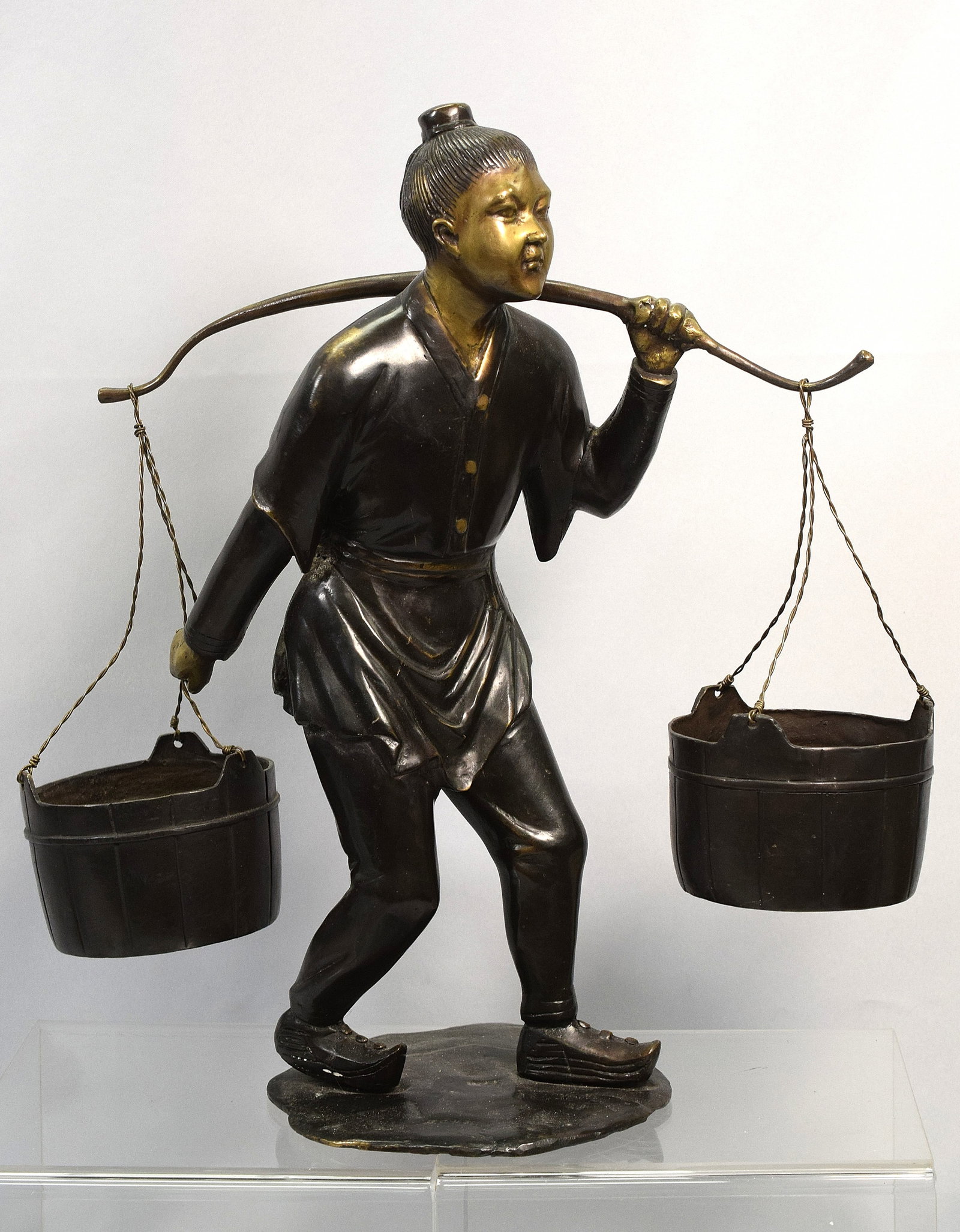JAPANESE BRONZE FIGURAL SCULPTURE: Vintage Japanese bronze sculpture. Detailed bronze of a man carrying two buckets. Patina bronze. 17 inches tall x 15 1/2 inches wide. Good condition. Not signed. The Estate of Nicholas