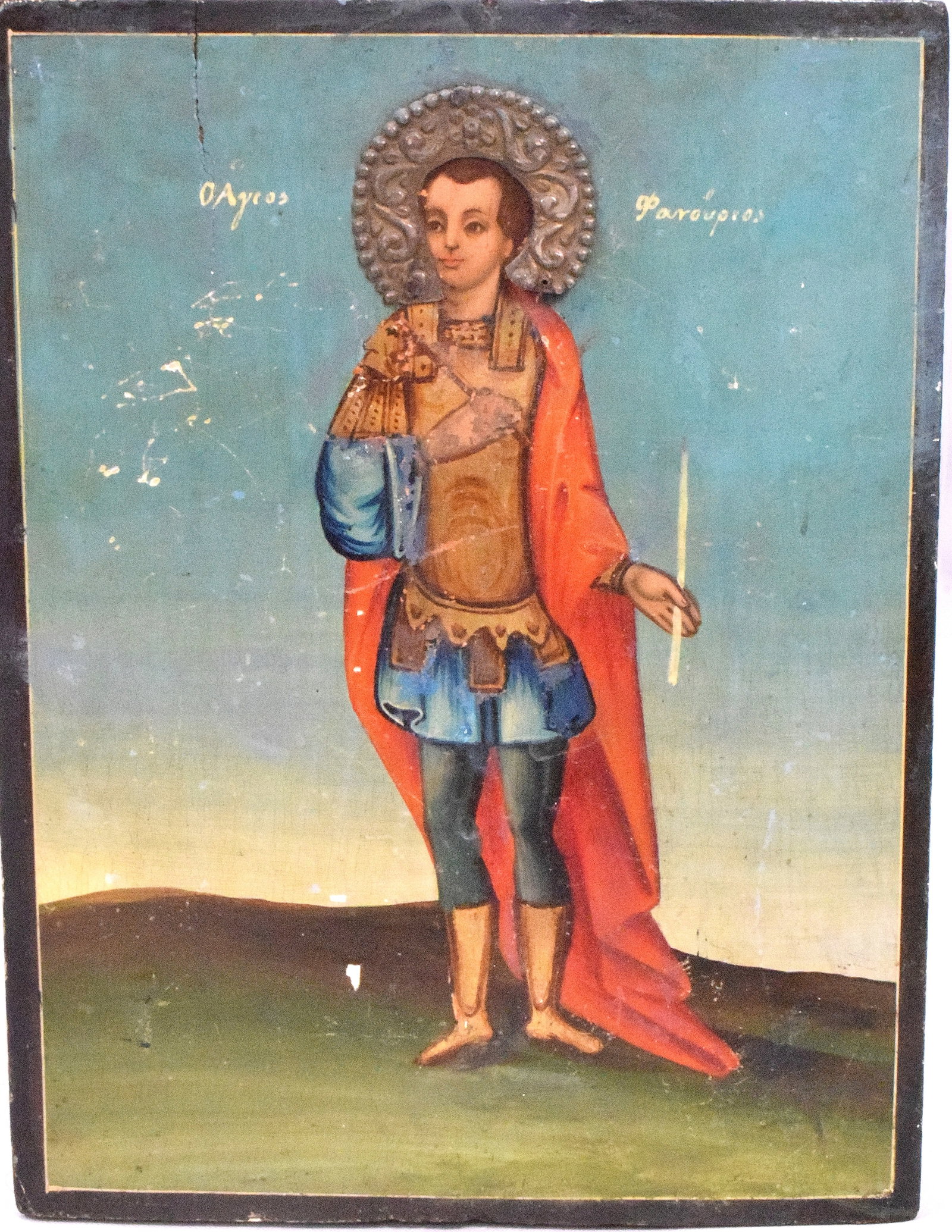 19TH CHRISTIAN ORTHODOX ICON ST PHANOURIOS: 19th century Christian Orthodox icon depicting Saint Phanourios holding candle and dressed in military attire. Oil on panel. Some in-painting. Black lighted. Applies silver Risa. Panel 9 3/4inches x 7
