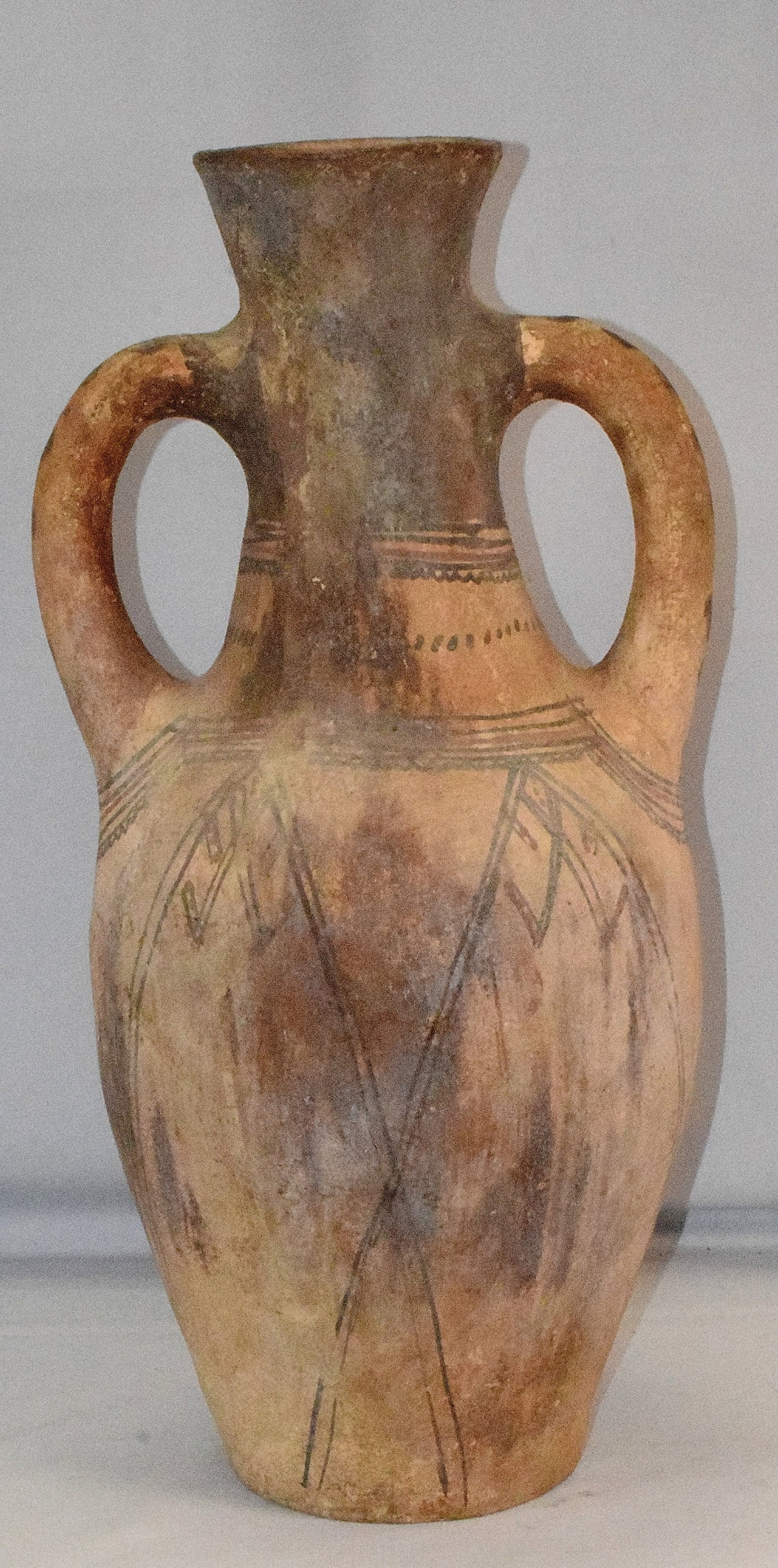 MOROCCAN BERBER POTTERY or CLAY JUG: Moroccan Berber jug. Made of pottery or clay, 19th//20th century. 21 inches tall x 10 1/2 inches handle to handle. Double handle. Various geometric designs. 2 colors. Cracks in side.Visible in