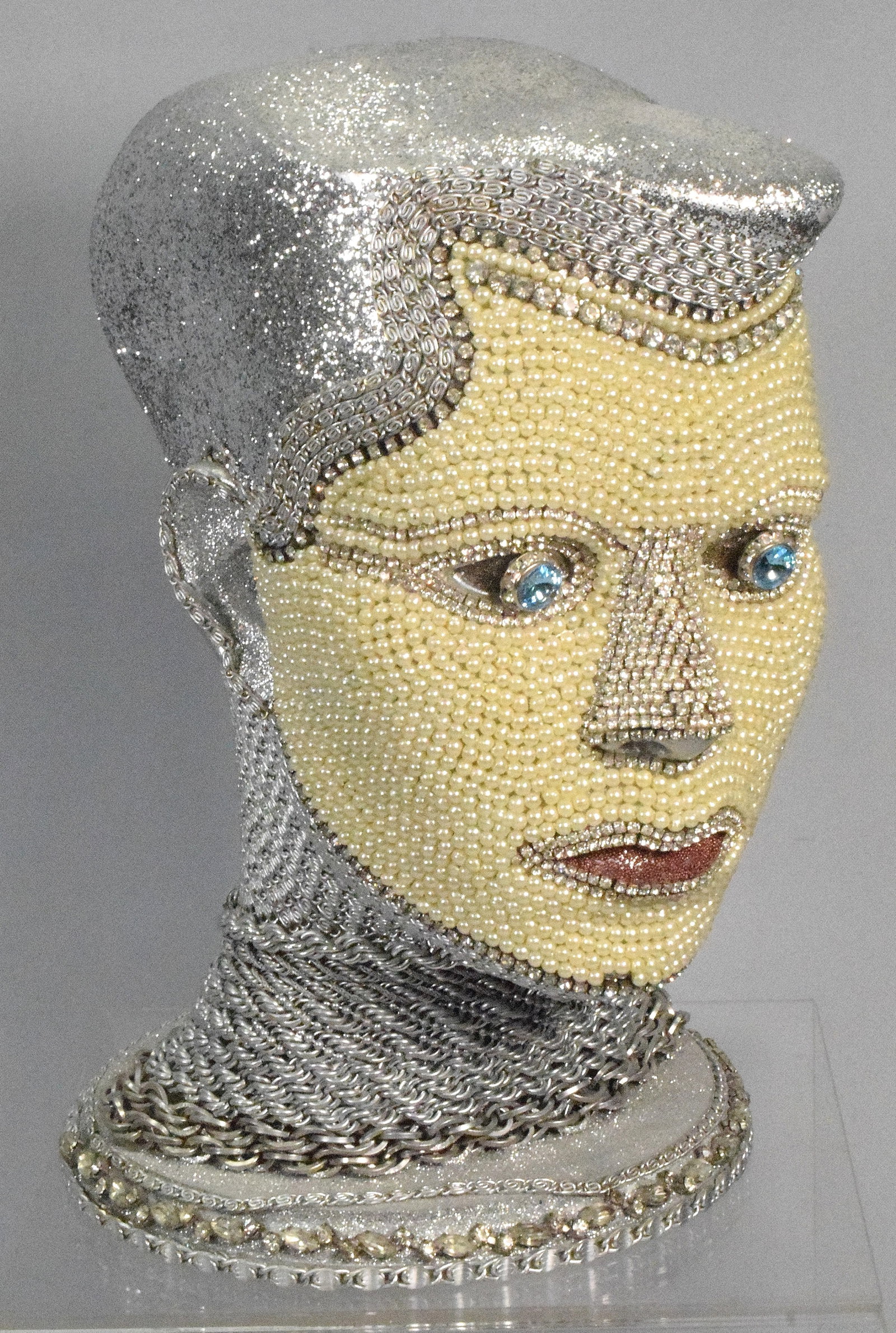 WILLIAM BEAUPRE CHAIN MAIL ANDROID BUST: William Beaupre (Artist) chain mailandroid bust. Depicts female bust with blue eyes. Silver starkles, rhinestones, paste pearls and etc. 10 1/2 inches tall. An artist known for creatingunique, futuris