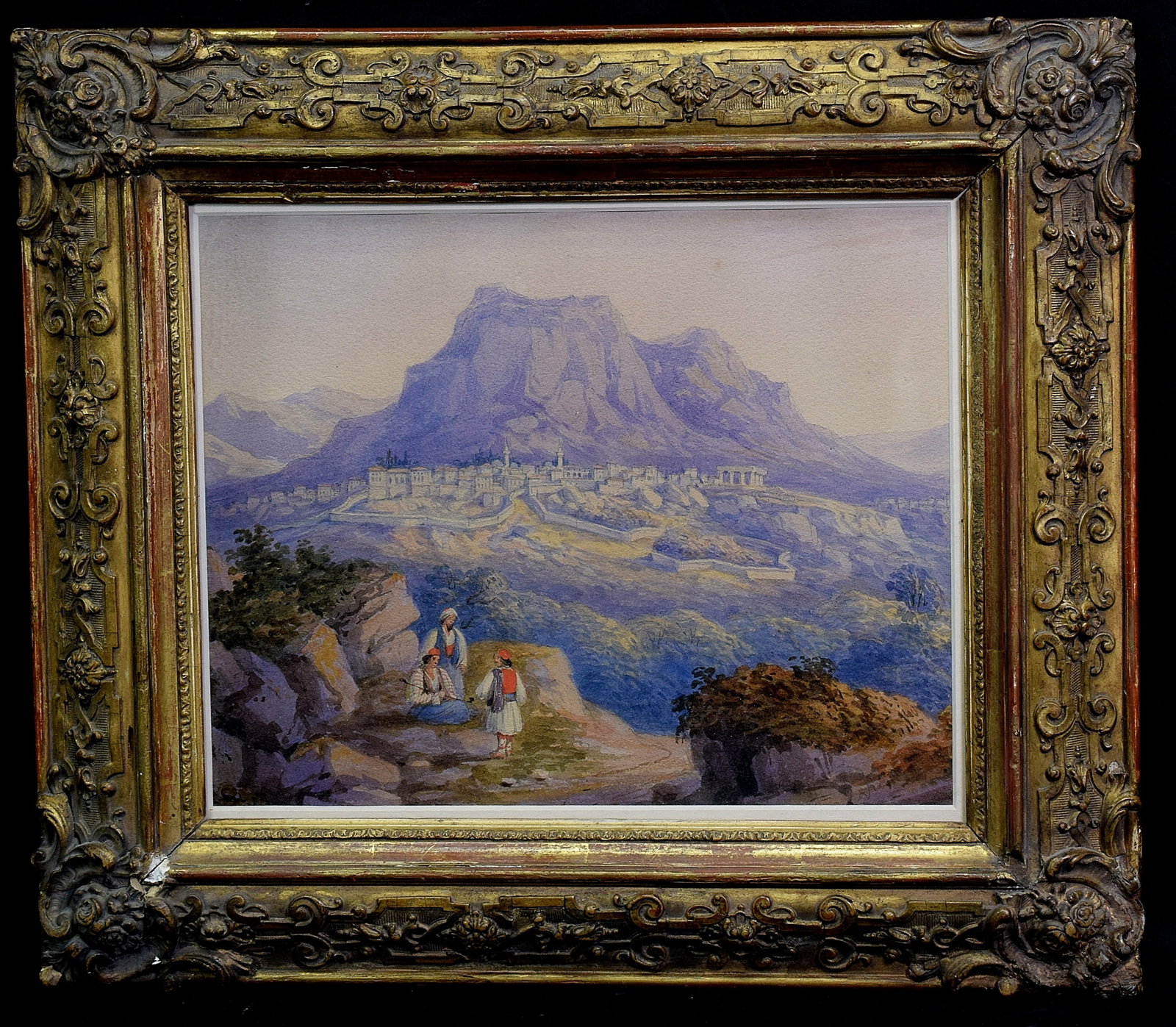 19TH WATERCOLOR PAINTING OF AKROKORINTHOS: 19th century Greek watercolor painting on paper of the Akrokorrinthos. Depicts three figures to lower left. Akrokorinthos in landscape background. Image 9 1/2 inches x 12 inches. Frame 15 inches x 17