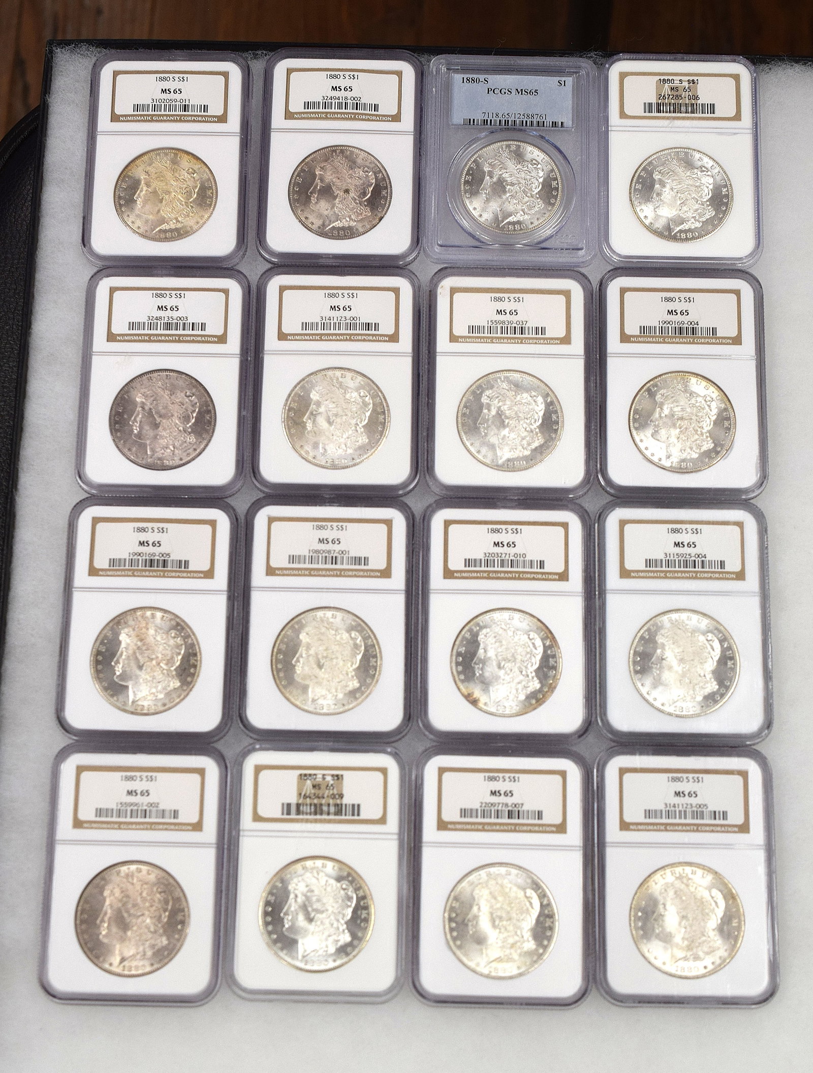 16 GRADED MS-65 1880s SILVER US MORGAN DOLLARS: 16 US Silver Morgan dollars. All are Graded MS 65. White's Auctions will not take credit cards on gold jewelry, gold coins, silver or bullion and does not grade coins