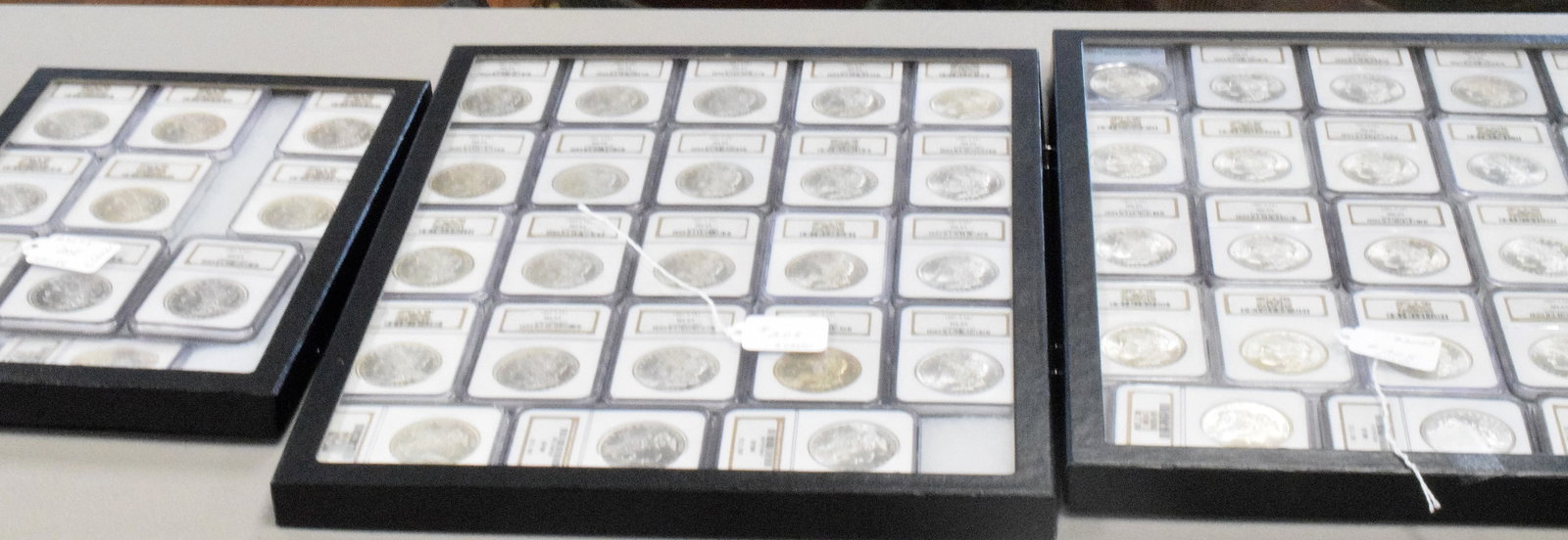 56 GRADED US SILVER MORGAN DOLLARS 1881s: 56 each graded MS-65. Each dated 1881's. White's Auctions will not take credit cards on gold jewelry, gold coins, silver or bullion and does not grade coins