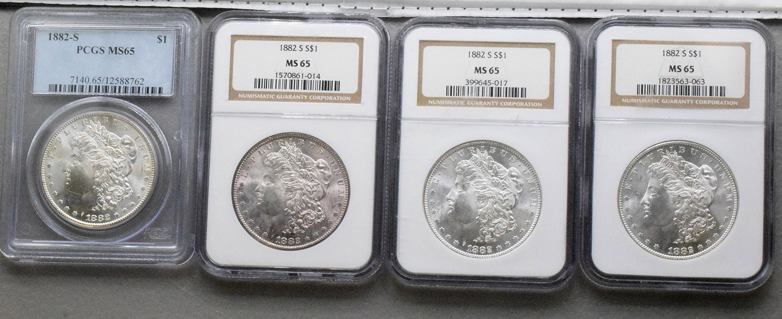 4 GRADED US SILVER MORGAN DOLLARS, 1882s: 4 each graded MS-65. Each dated 1882's. White's Auctions will not take credit cards on gold jewelry, gold coins, silver or bullion and does not grade coins